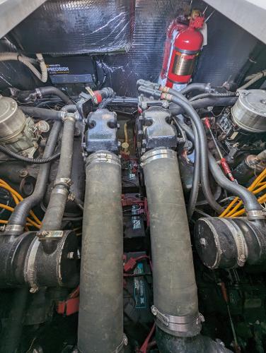 Engine compartment of a 1992 Sea Ray 330 Express Cruiser with visible components and fire extinguisher.