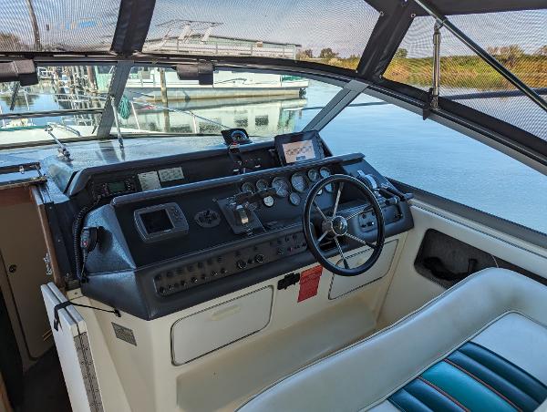 Cockpit of 1992 Sea Ray 330 Express Cruiser with steering wheel and control panel.