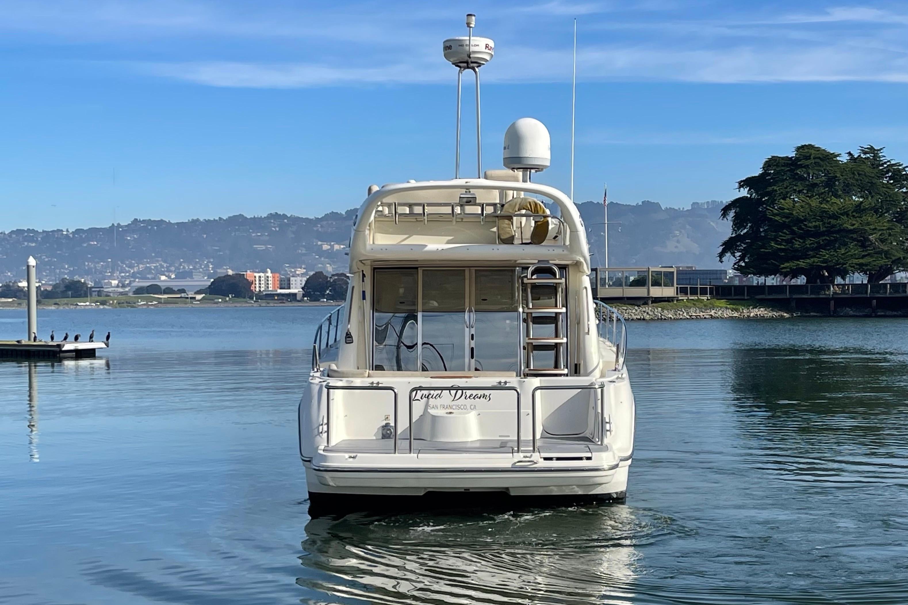 2003 Cranchi Atlantique 40 yacht on calm water with scenic background.