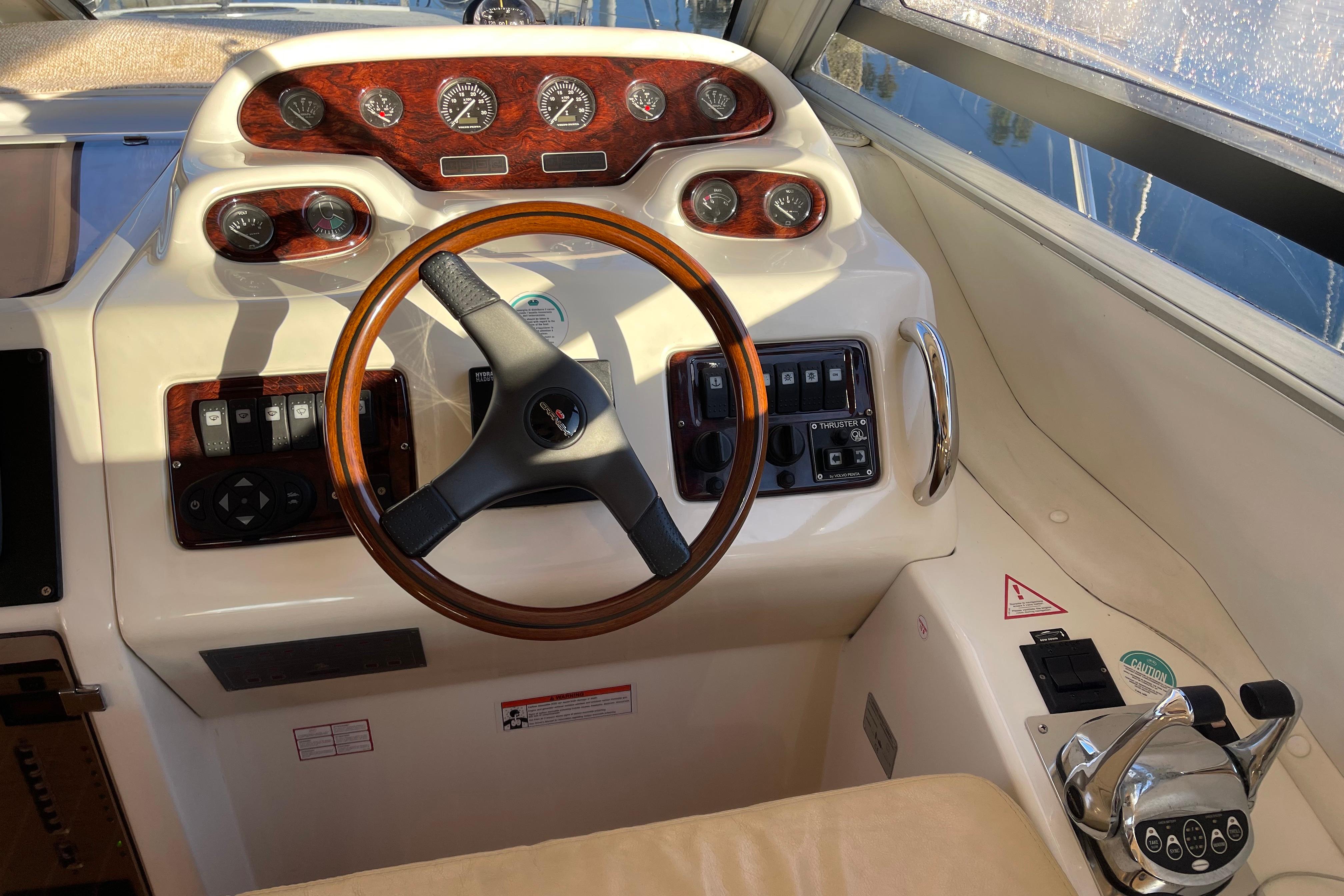 2003 Cranchi Atlantique 40 yacht helm with wood accents and modern controls.
