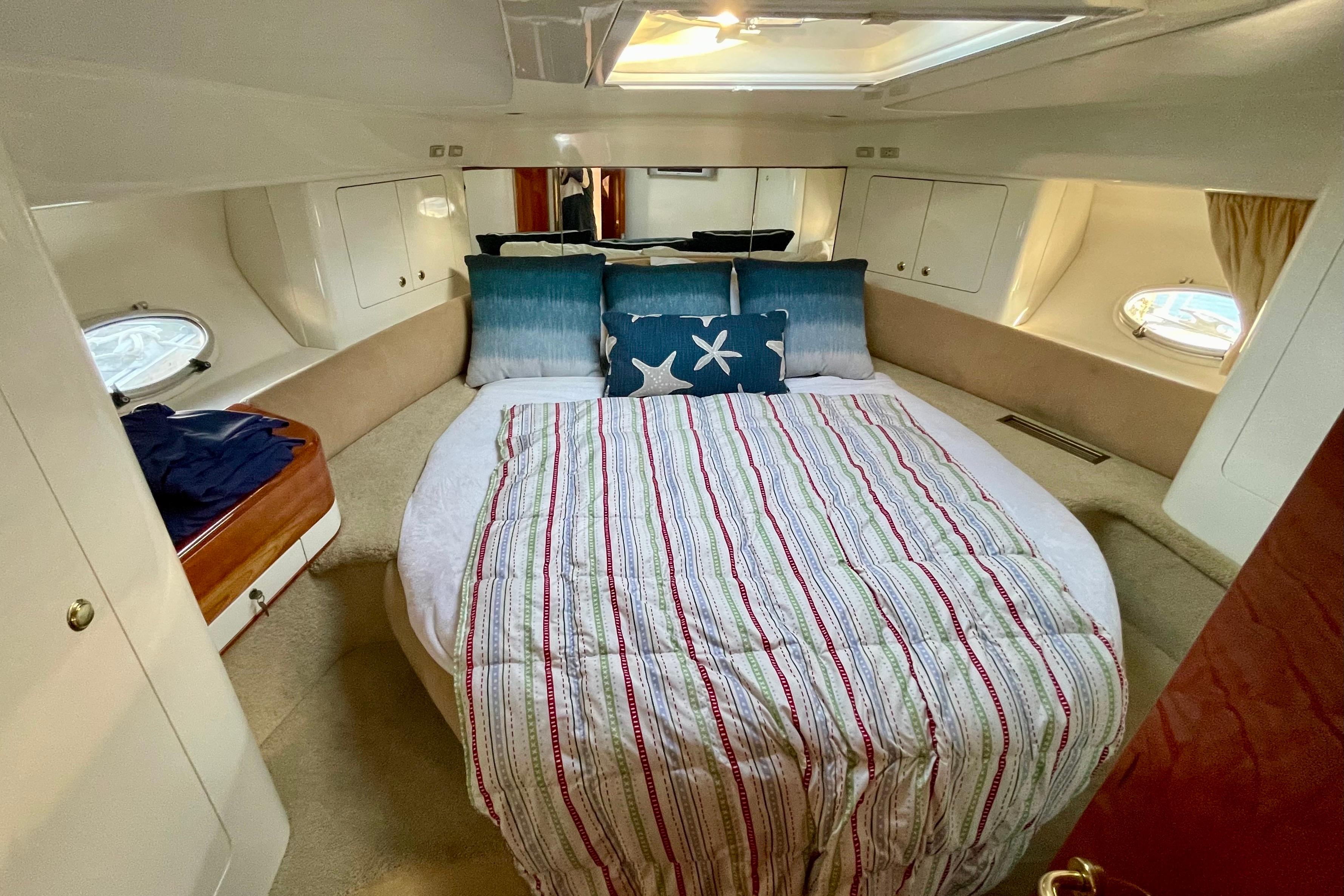 Luxurious cabin interior of 2003 Cranchi Atlantique 40 yacht with cozy bedding.
