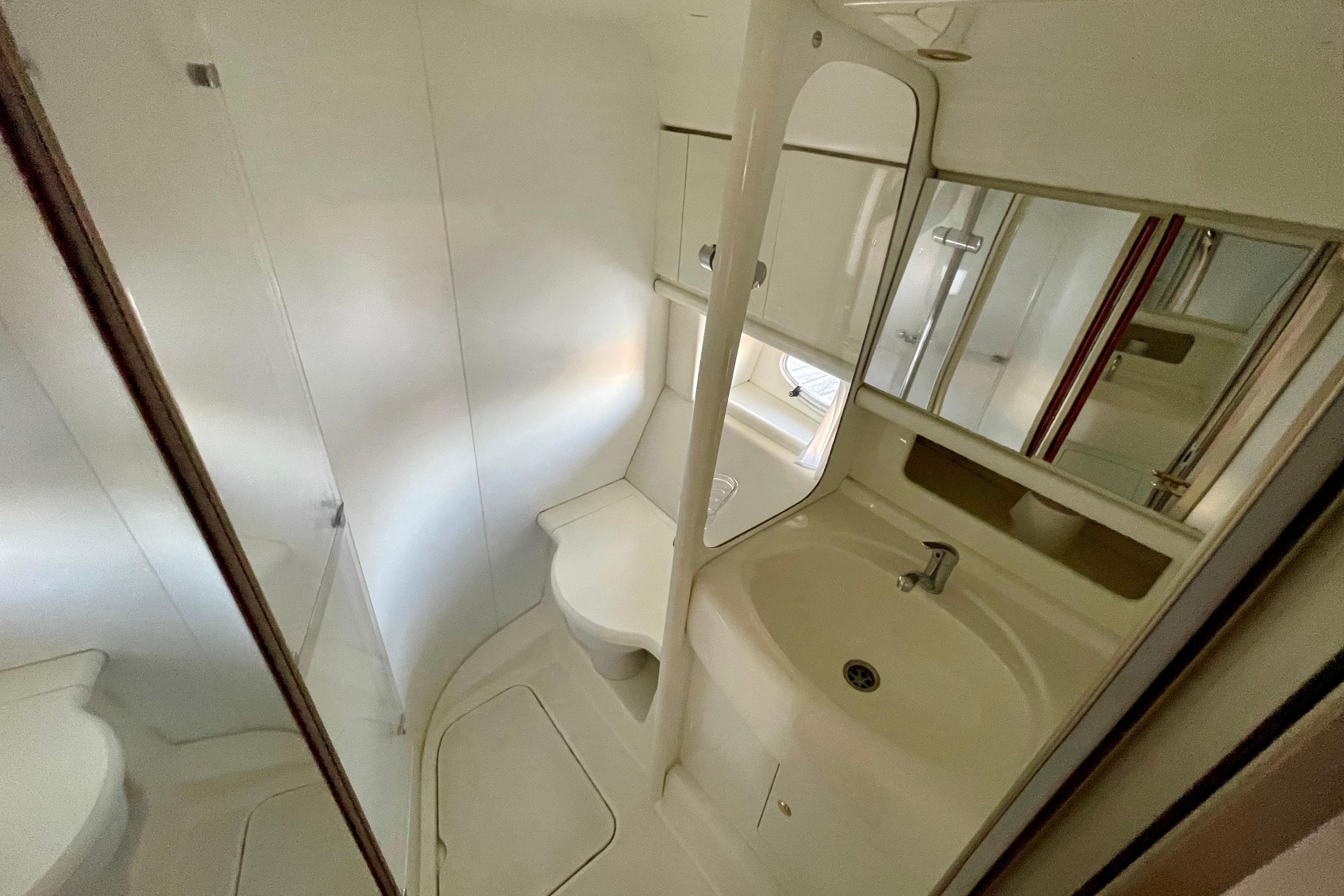 Bathroom interior of 2003 Cranchi Atlantique 40 yacht, featuring sink and mirror.