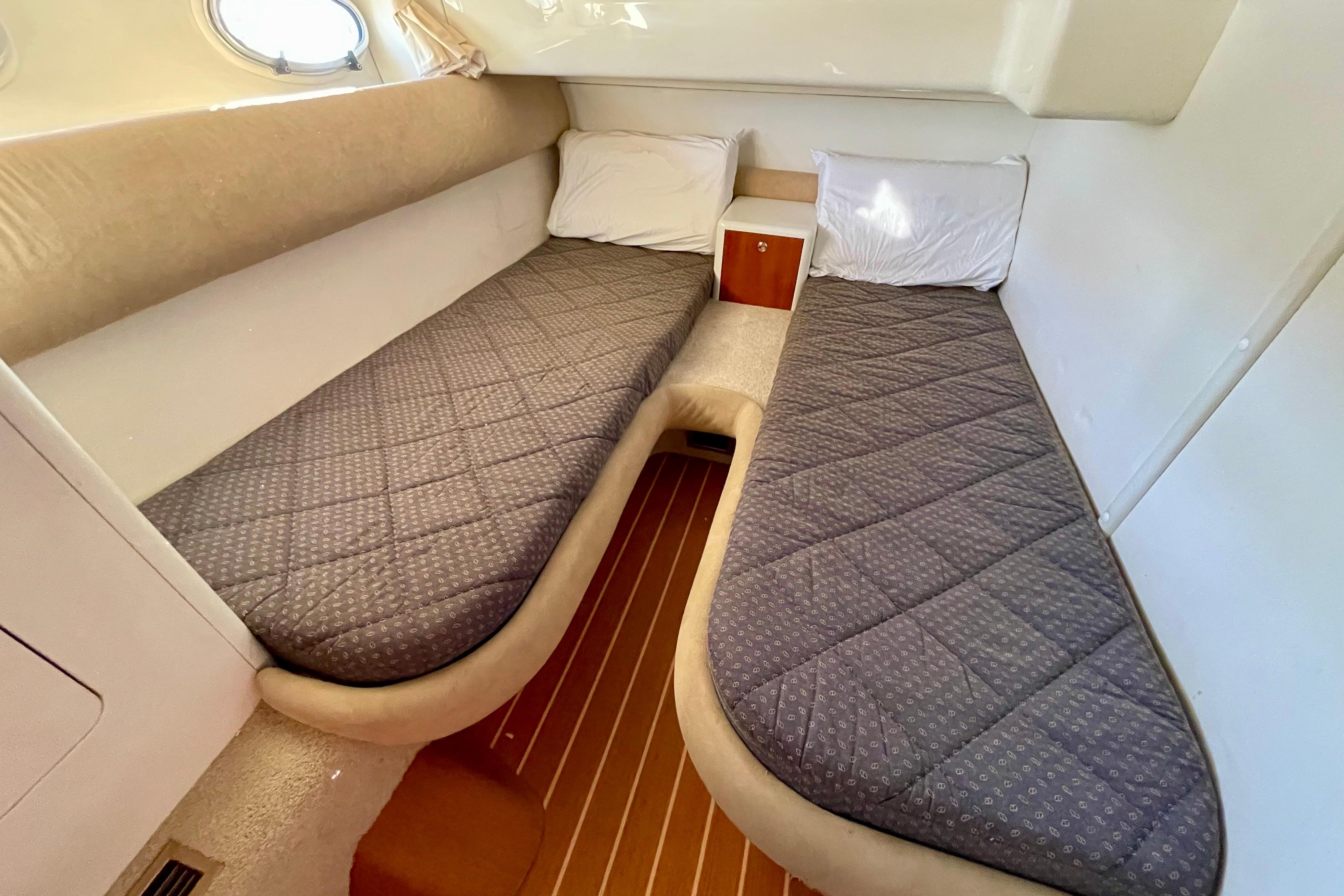 Twin cabin interior of 2003 Cranchi Atlantique 40 yacht with gray bedding.