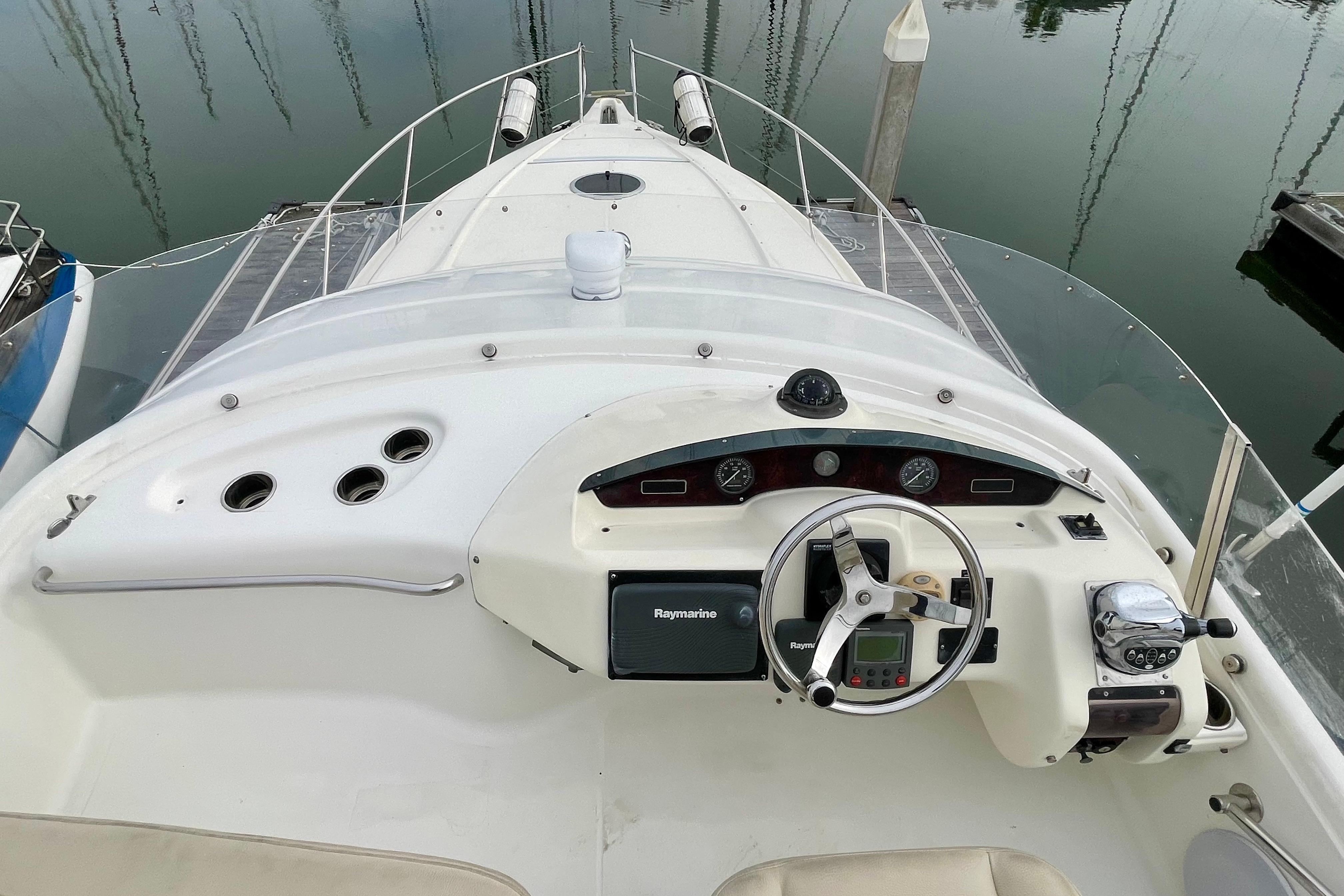 2003 Cranchi Atlantique 40 yacht helm with steering wheel and navigation instruments.