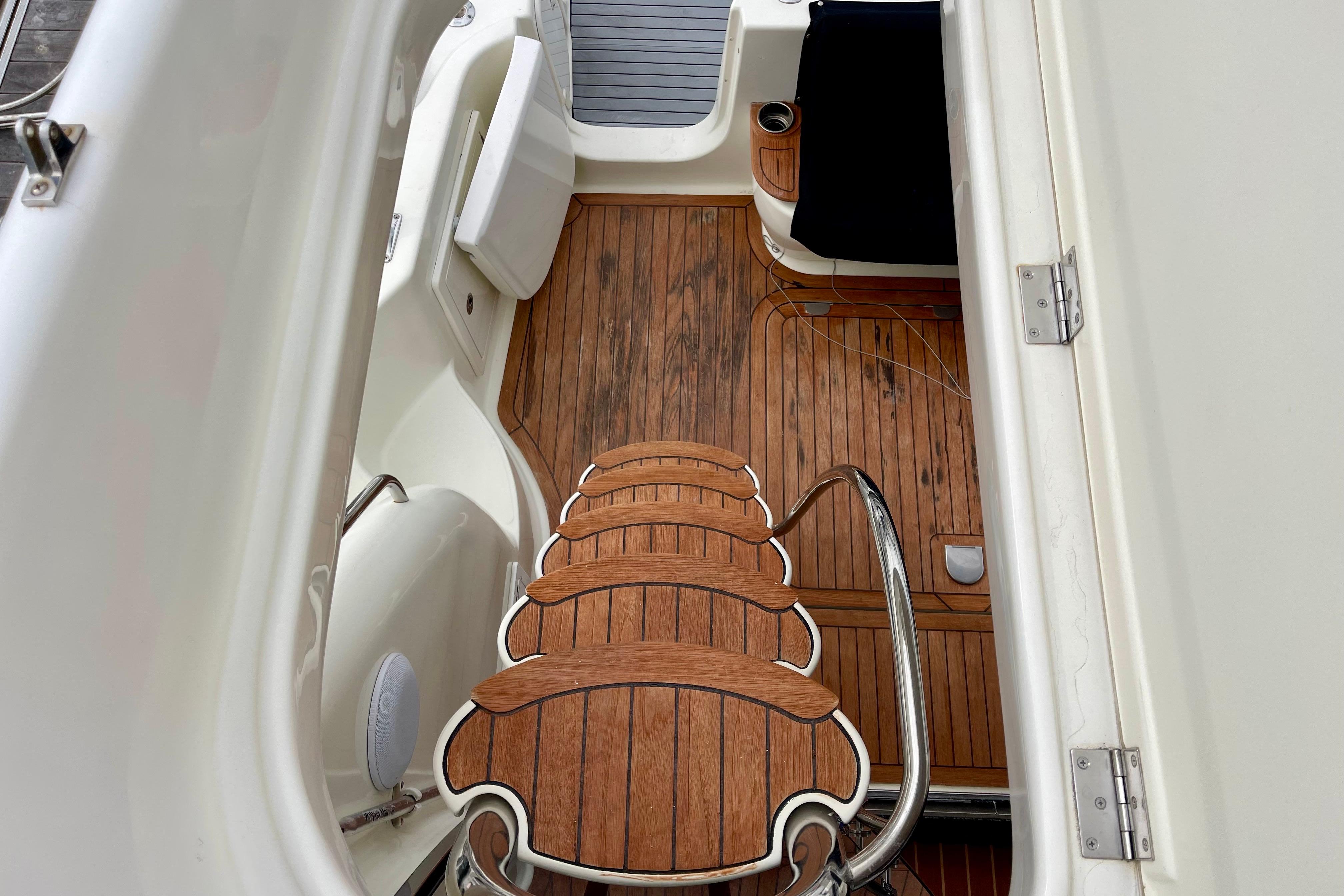 Staircase on 2003 Cranchi Atlantique 40 yacht with wooden deck and seating area.