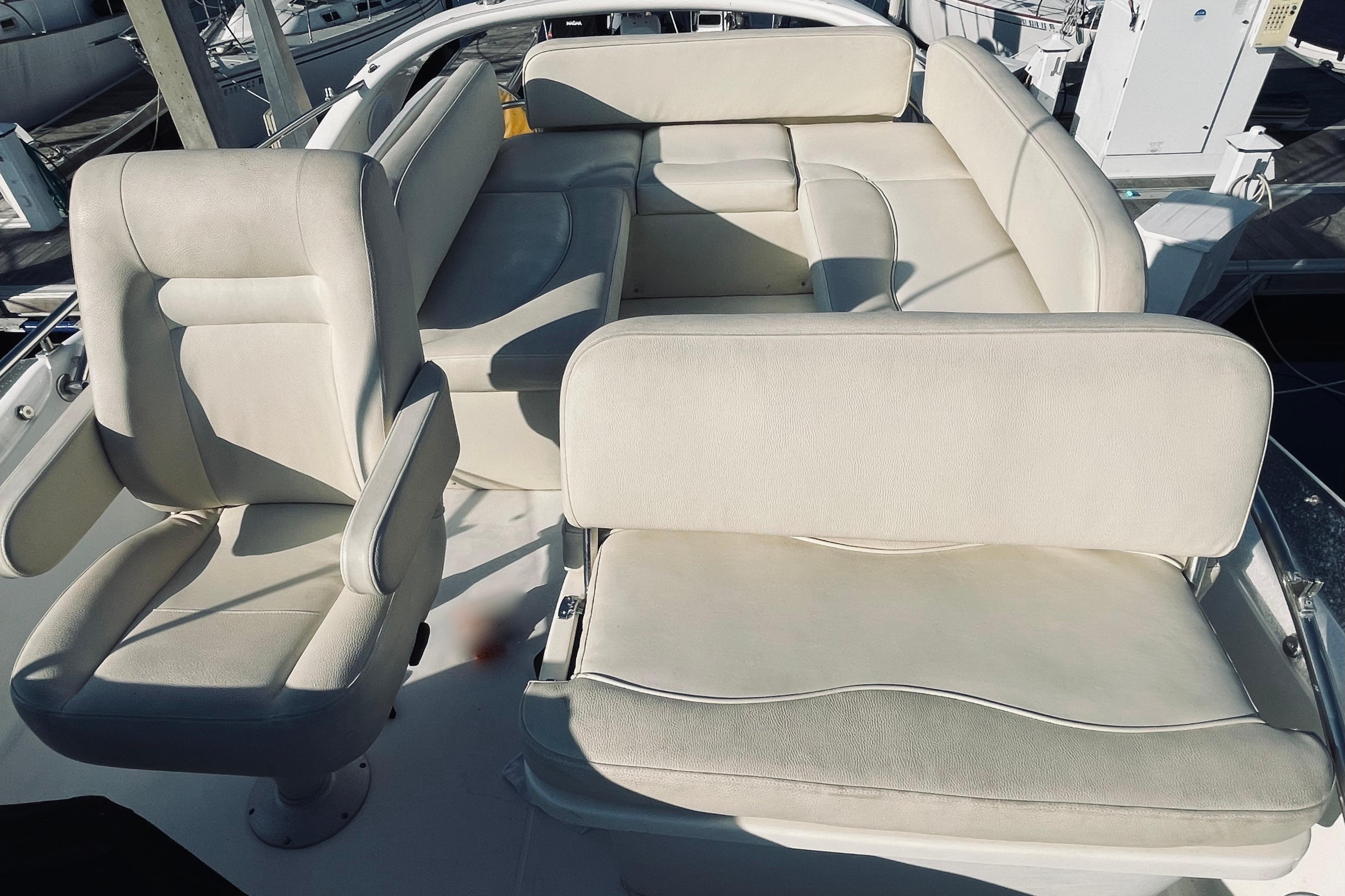 Luxurious seating on 2003 Cranchi Atlantique 40 yacht, featuring plush white upholstery.