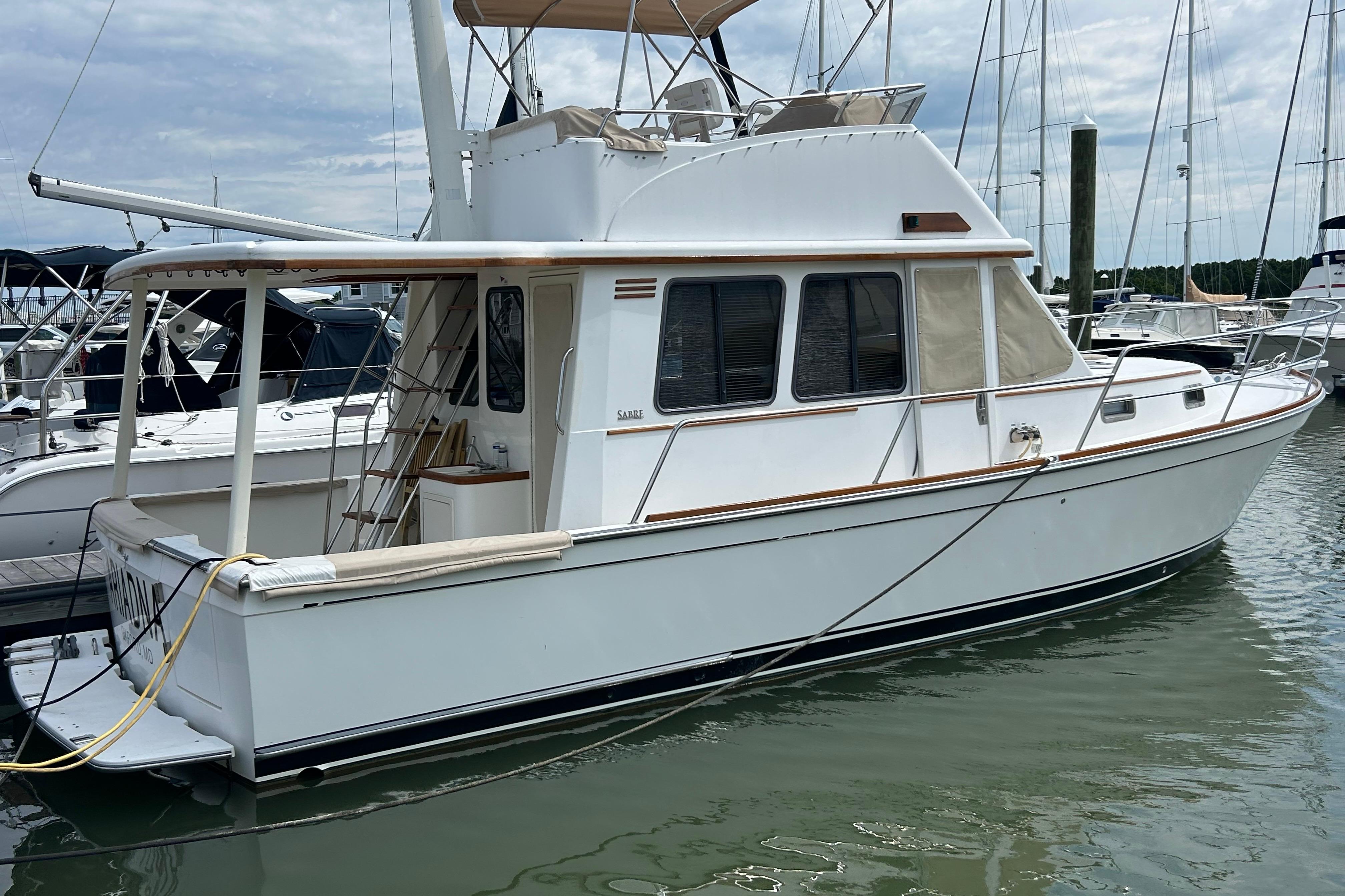 2004 Sabre 36 FB yacht docked at marina, featuring classic design and spacious deck.