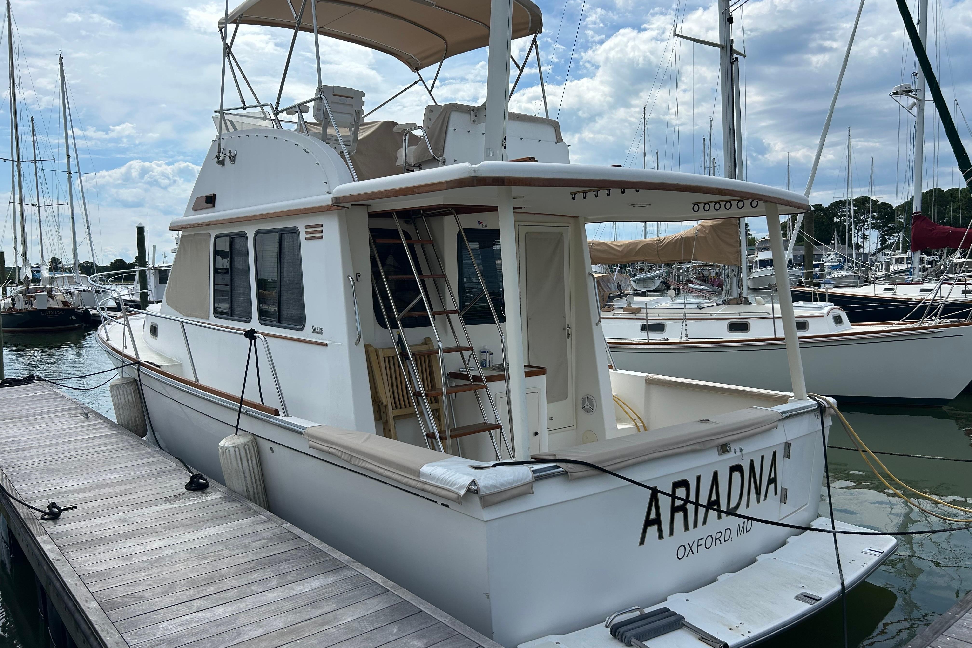 2004 Sabre 36 FB yacht docked at marina, featuring spacious deck and elegant design.
