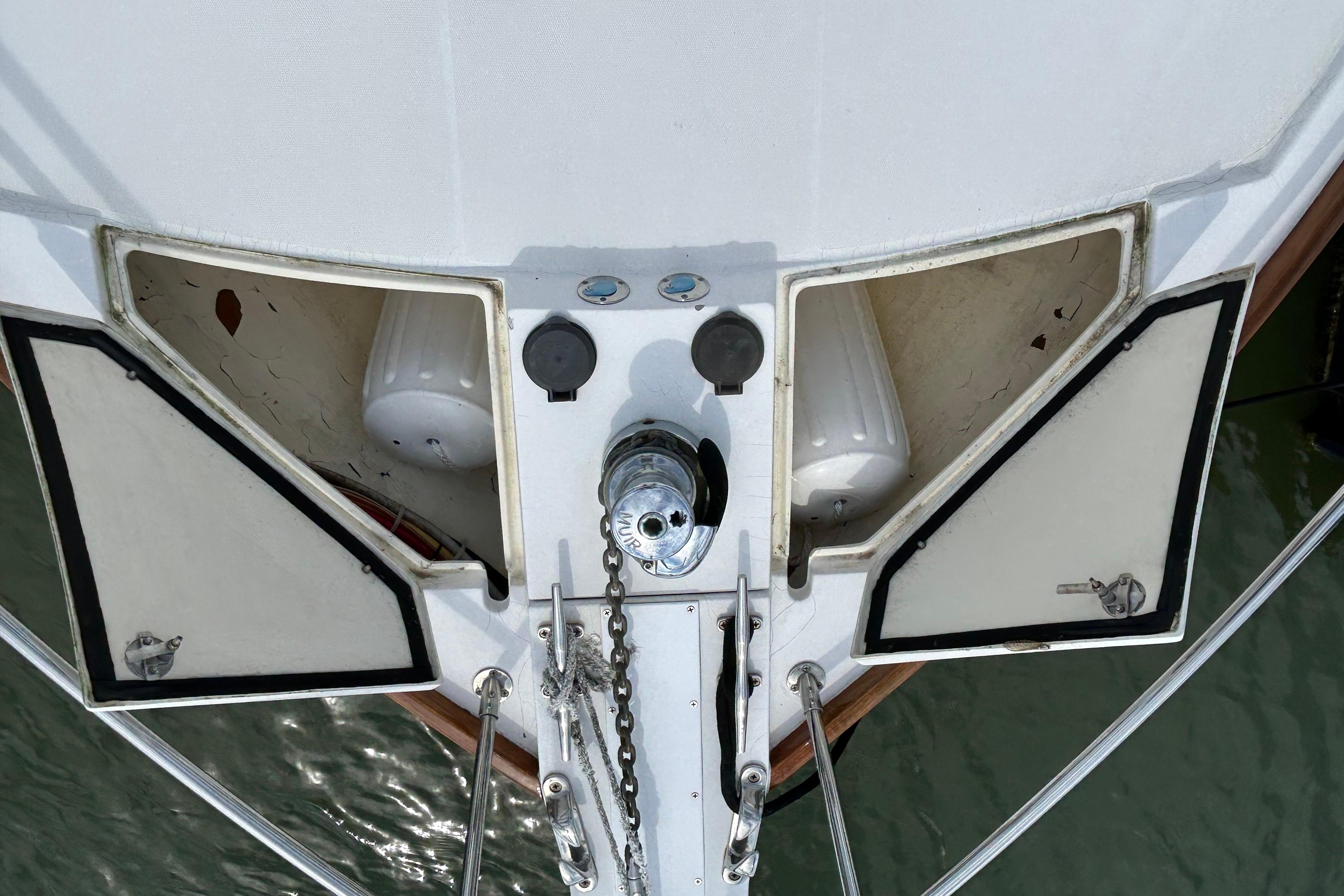 Bow view of 2004 Sabre 36 FB yacht with anchor chain and storage compartments.