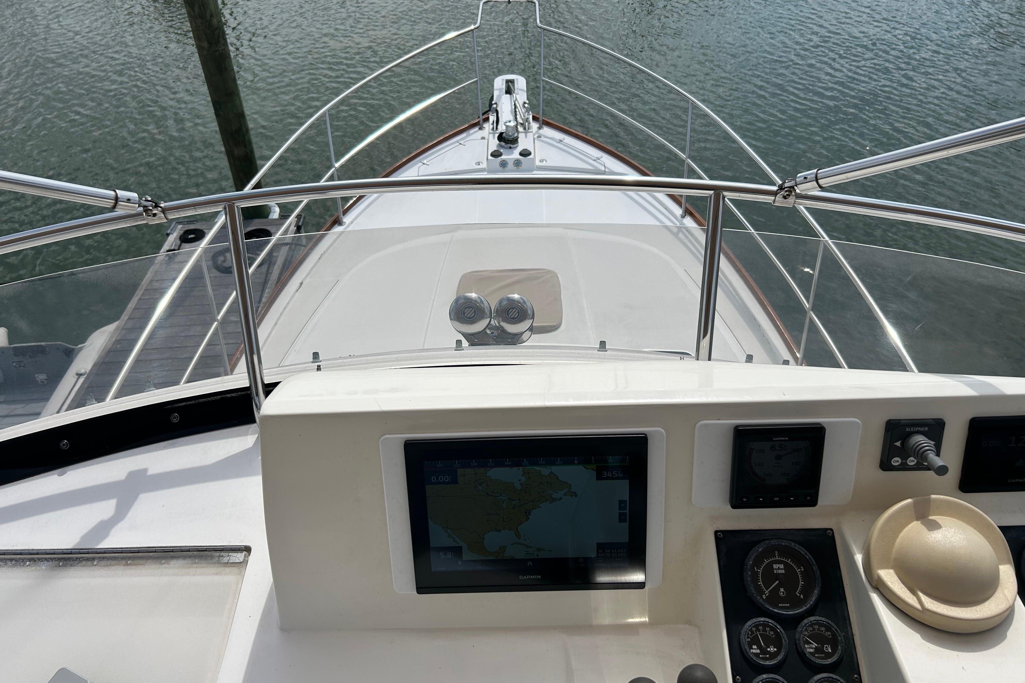 Helm view of 2004 Sabre 36 FB yacht with navigation equipment and water backdrop.