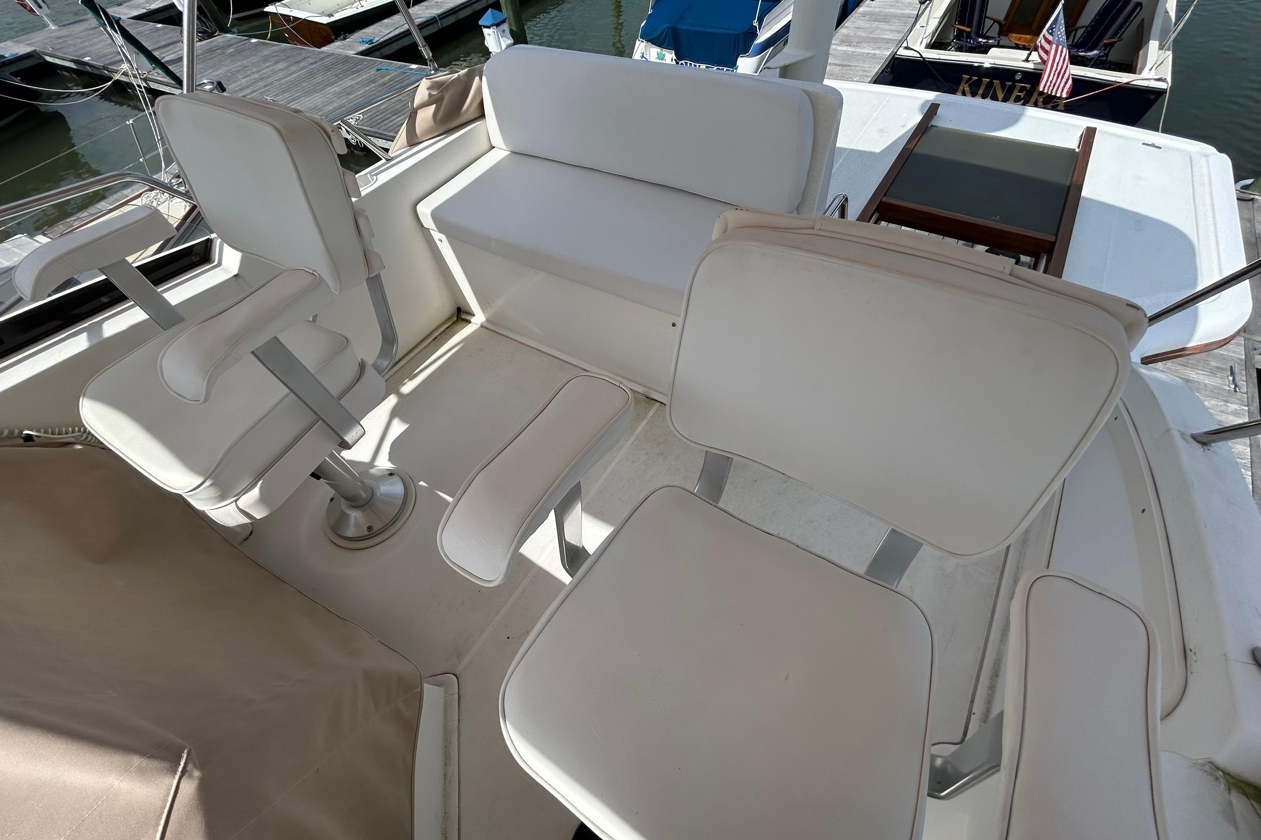 2004 Sabre 36 FB boat interior with white seating and dock view.