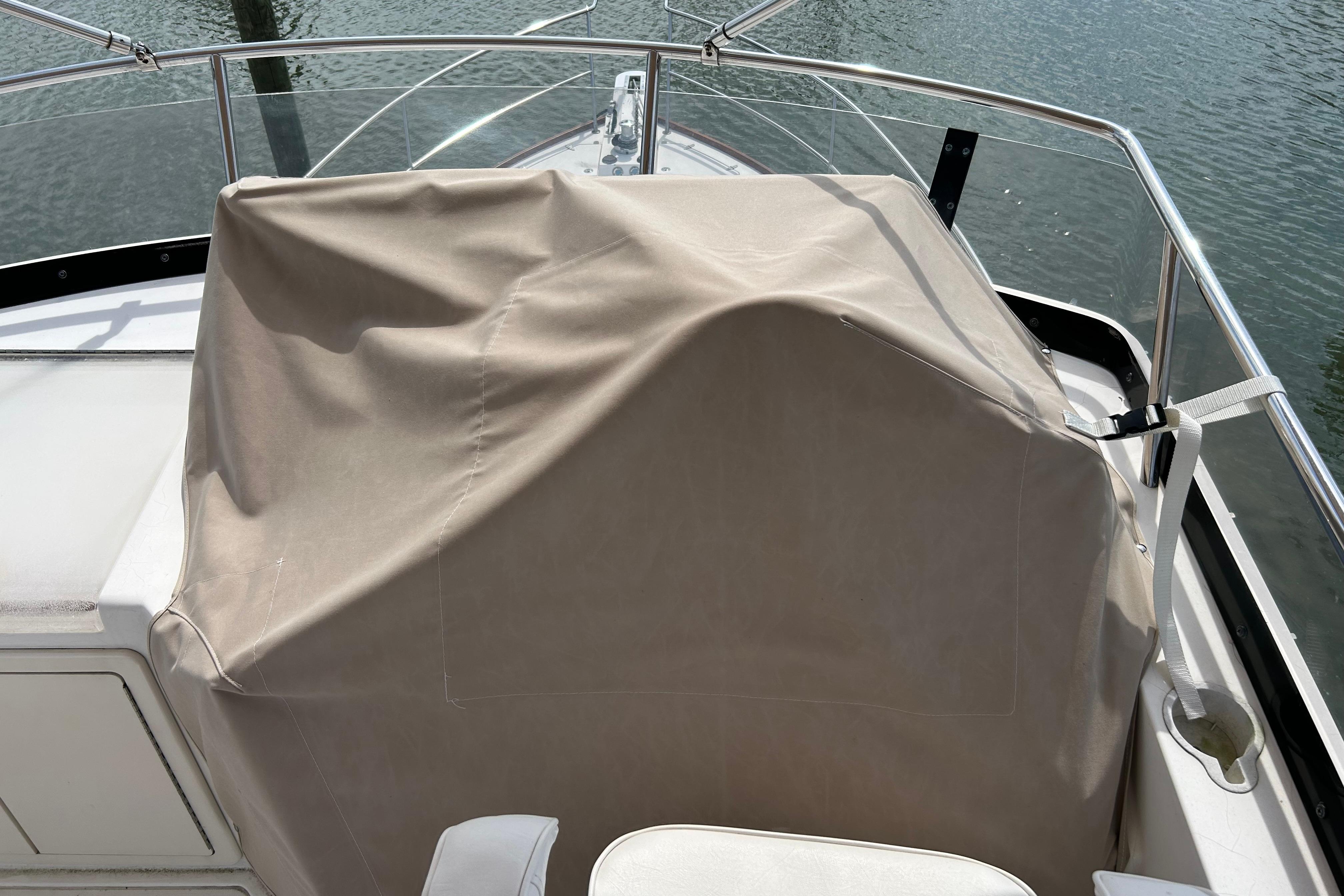 Covered helm station on a 2004 Sabre 36 FB boat, docked by the water.