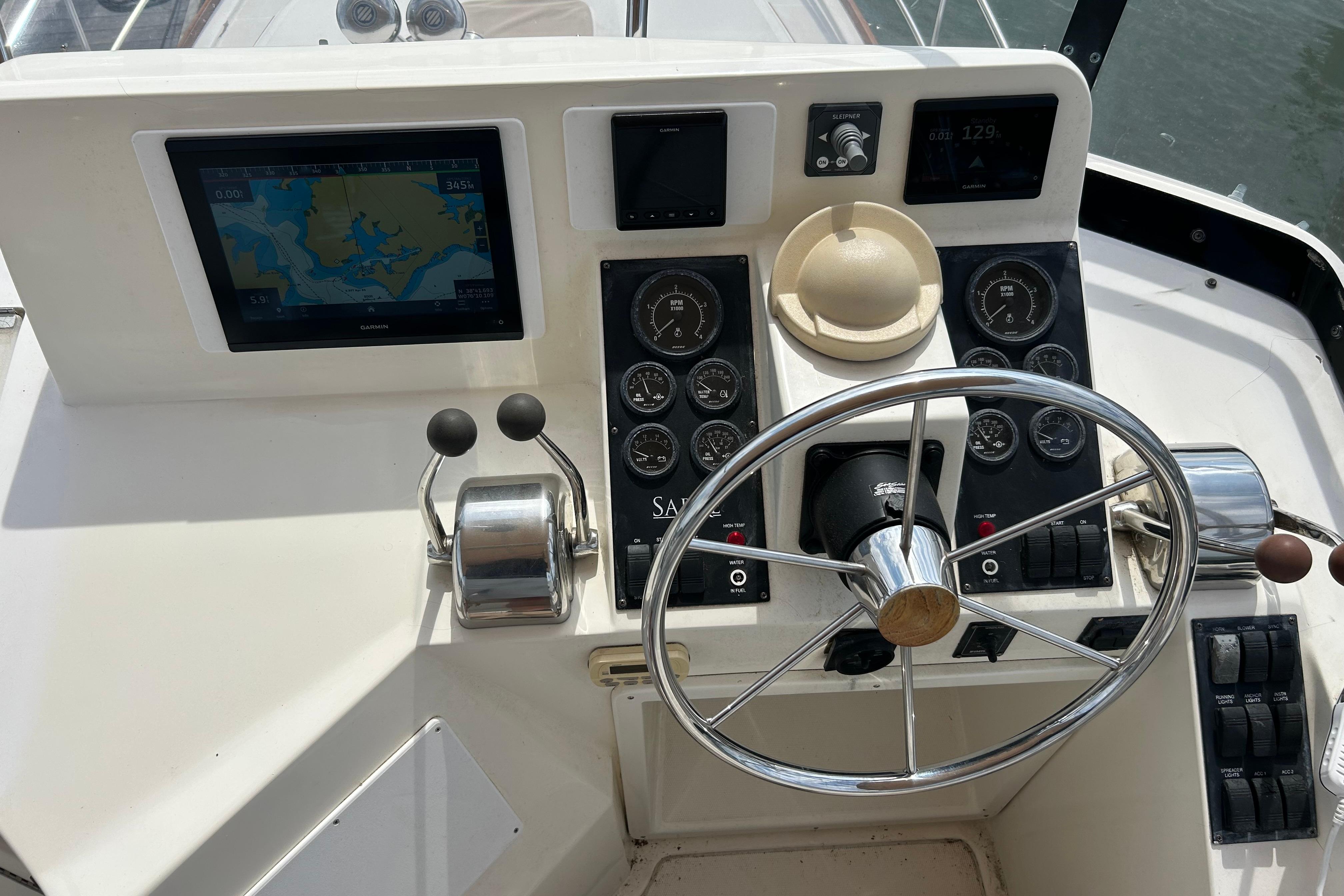 2004 Sabre 36 FB boat helm with navigation screen and steering wheel.