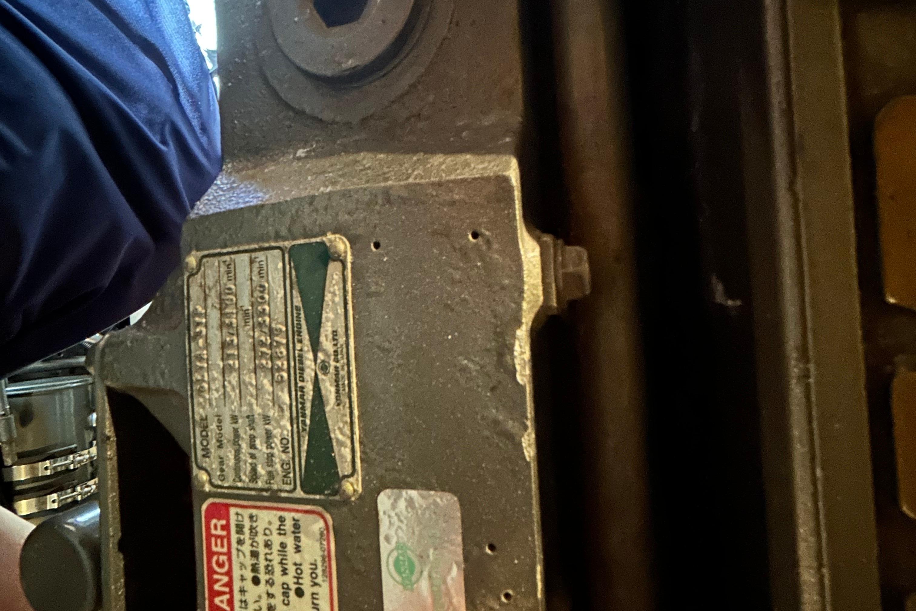 Close-up of a 2004 Sabre 36 FB engine component with warning labels.