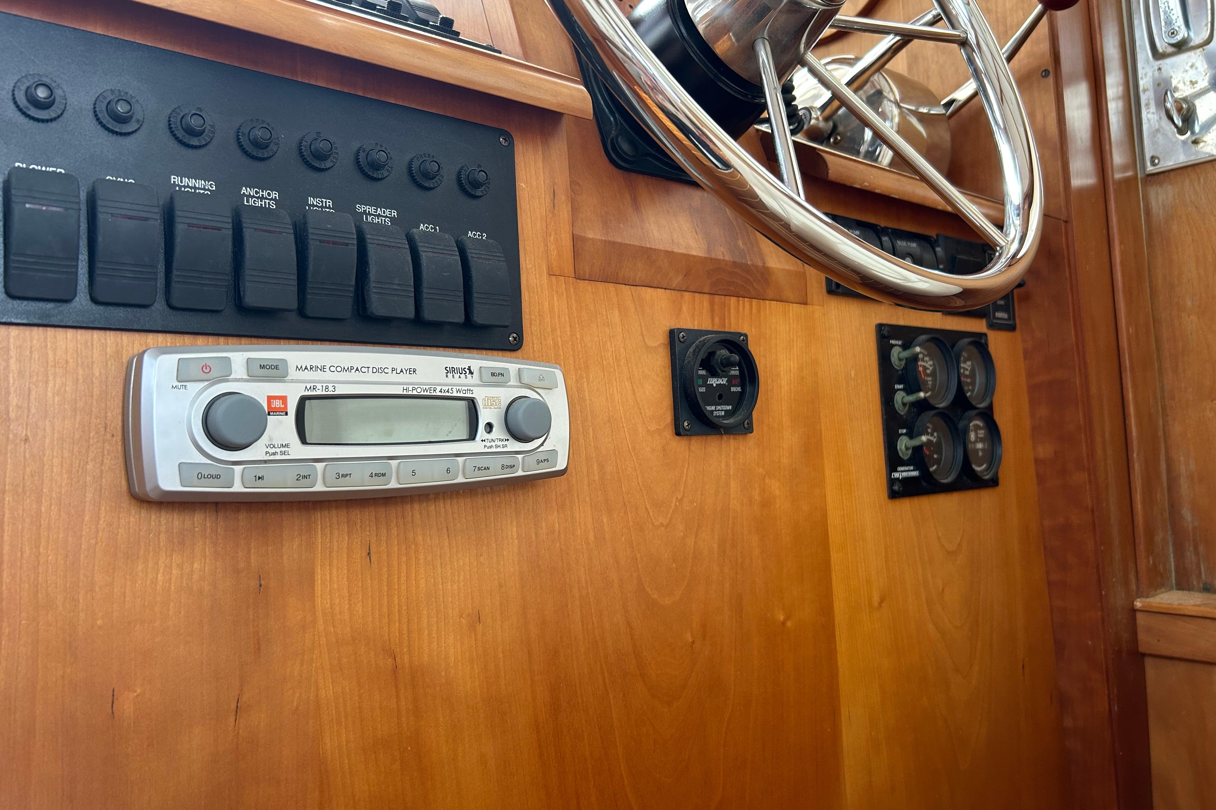2004 Sabre 36 FB boat dashboard with steering wheel, controls, and marine CD player.