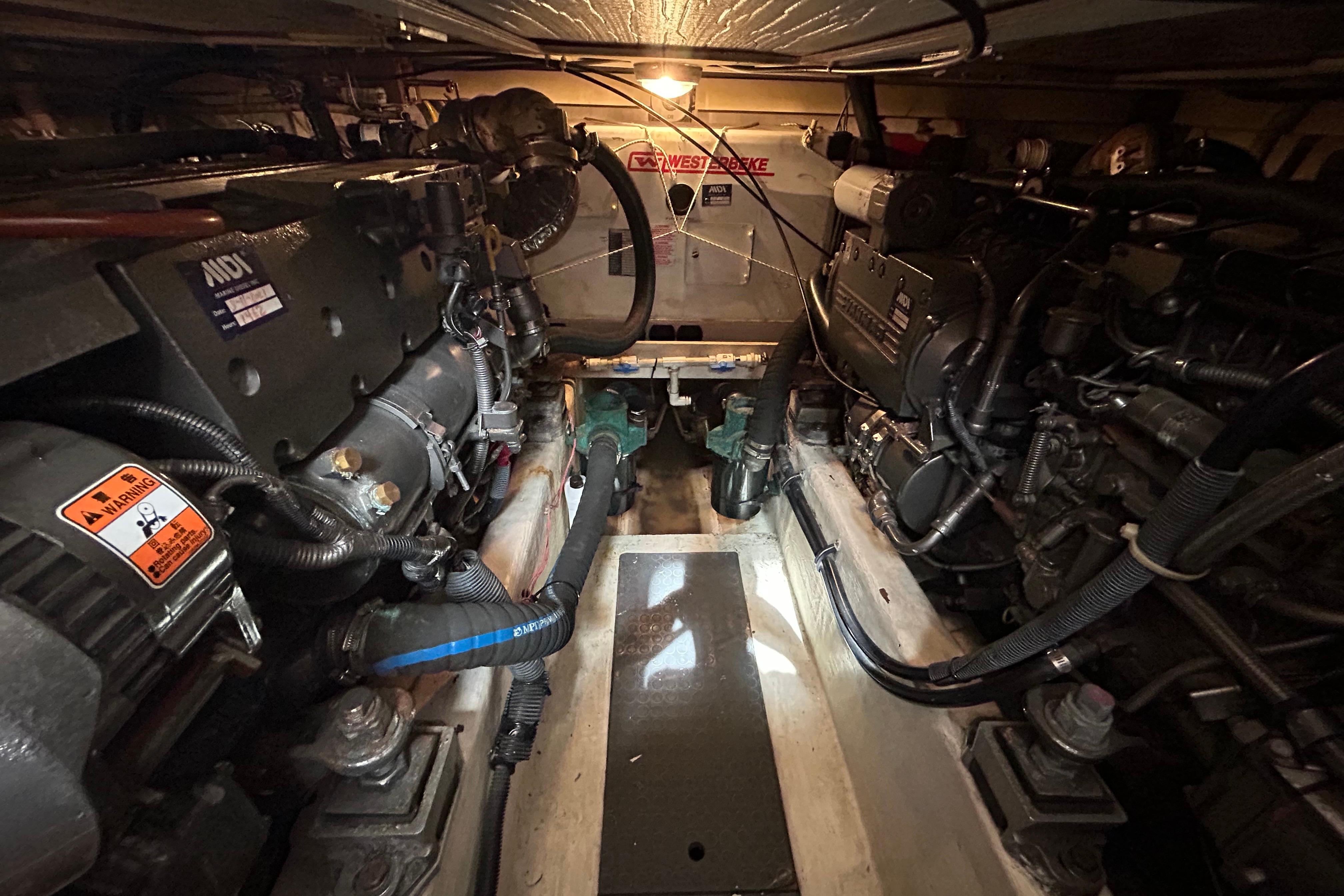 Engine room of 2004 Sabre 36 FB boat, featuring dual engines and mechanical components.