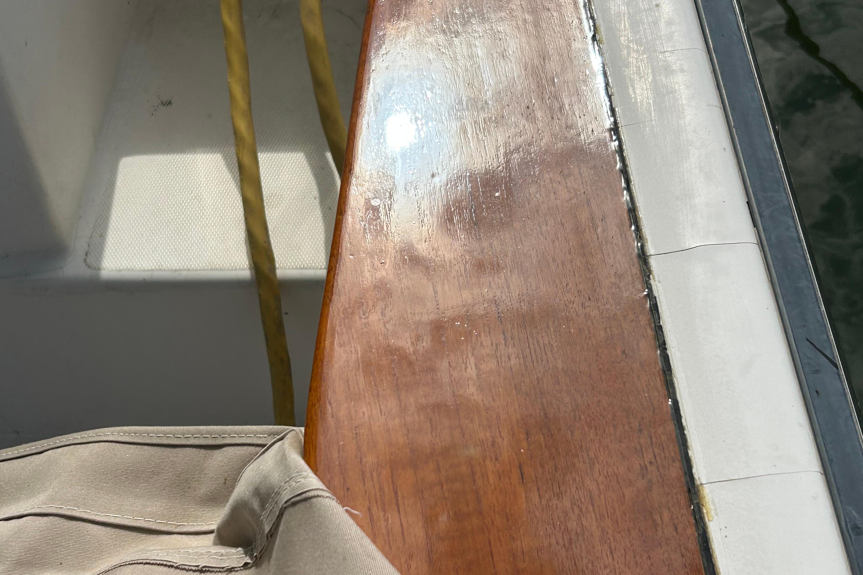 Polished wooden deck of 2004 Sabre 36 FB boat with sunlight reflection.