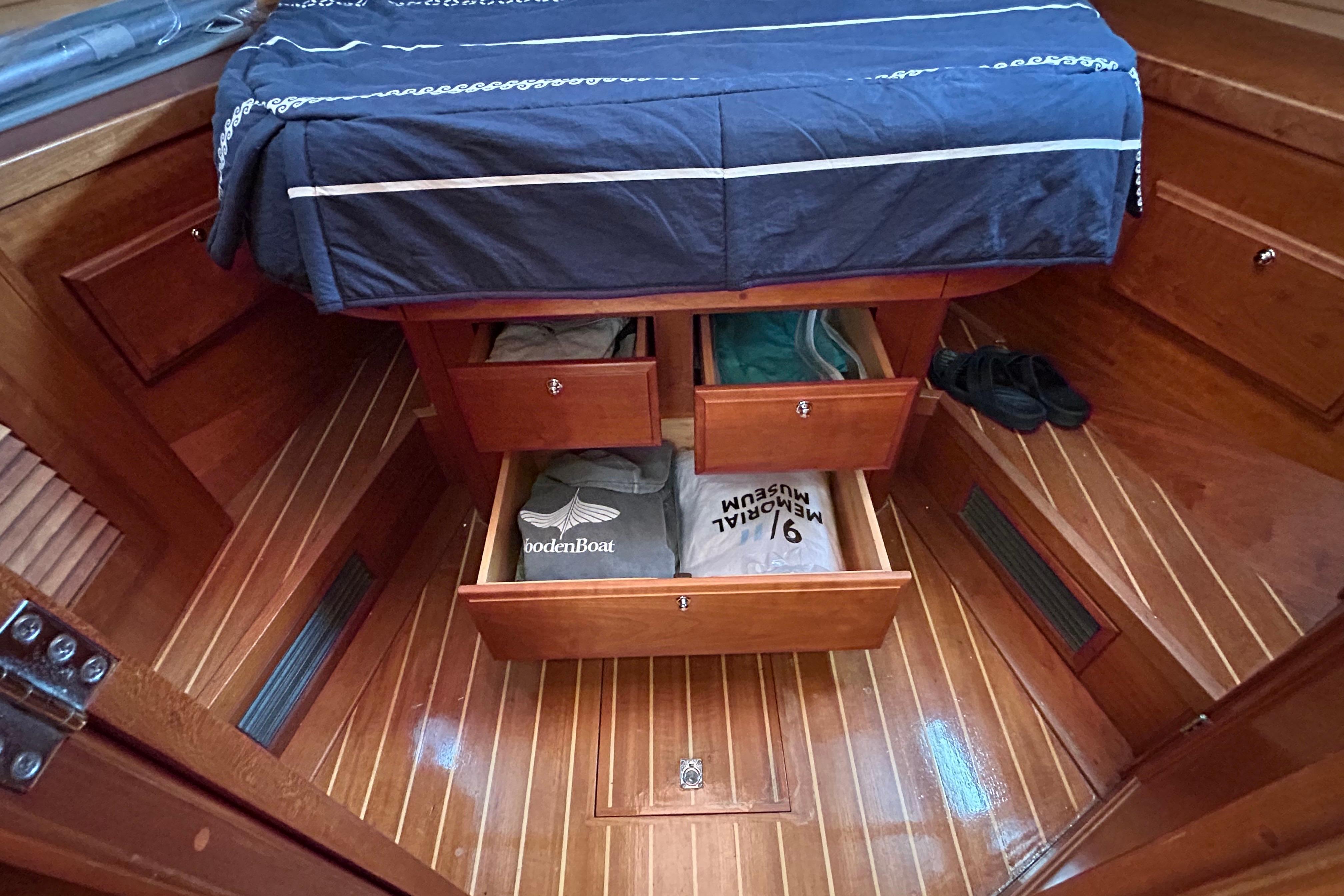 Interior of 2004 Sabre 36 FB boat with wooden flooring and storage drawers.
