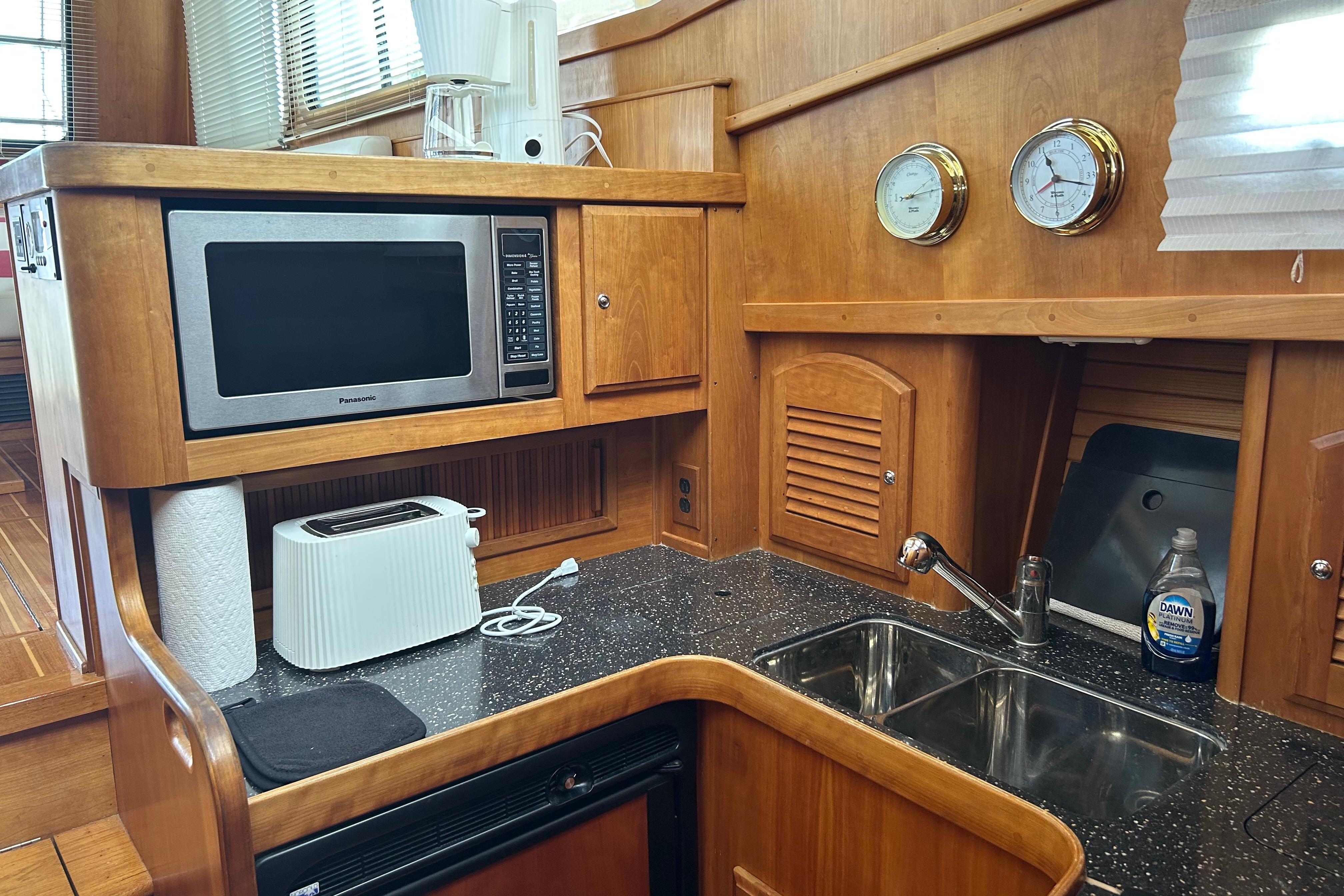 2004 Sabre 36 FB yacht kitchen with microwave, toaster, and dual sink.