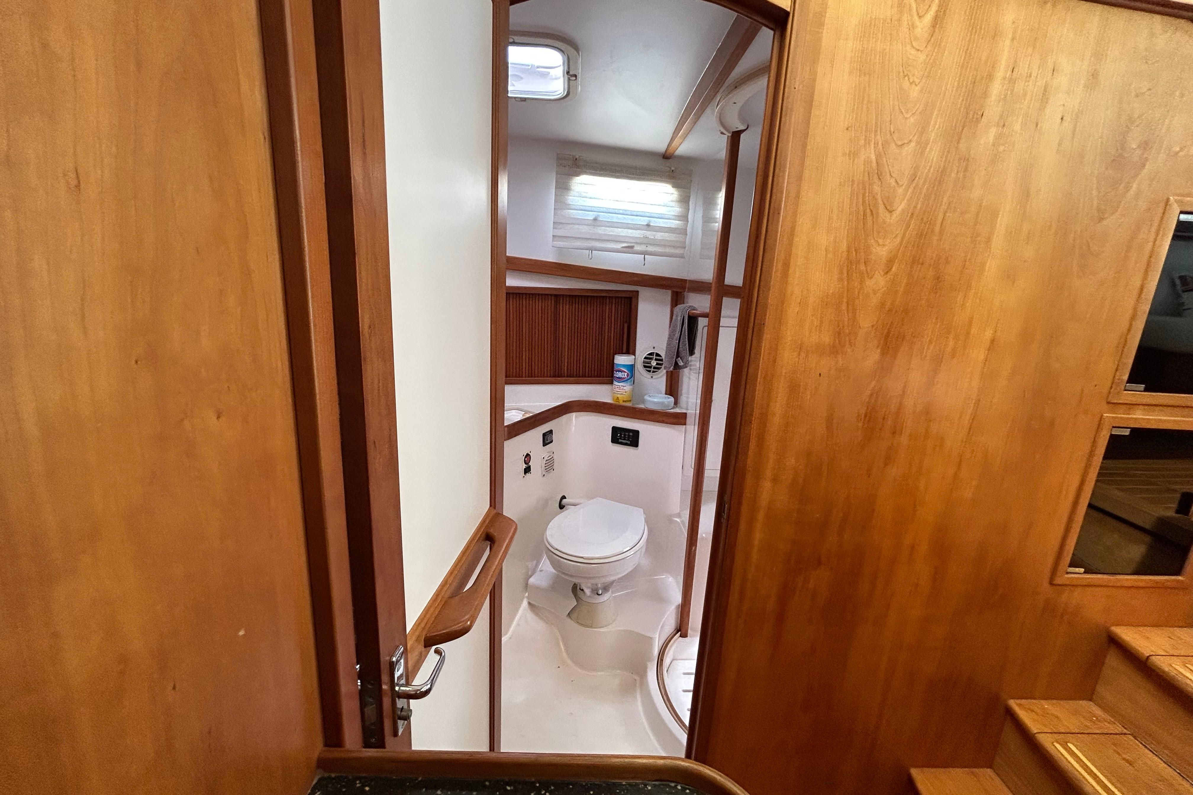 Interior view of 2004 Sabre 36 FB yacht bathroom with wooden finish.