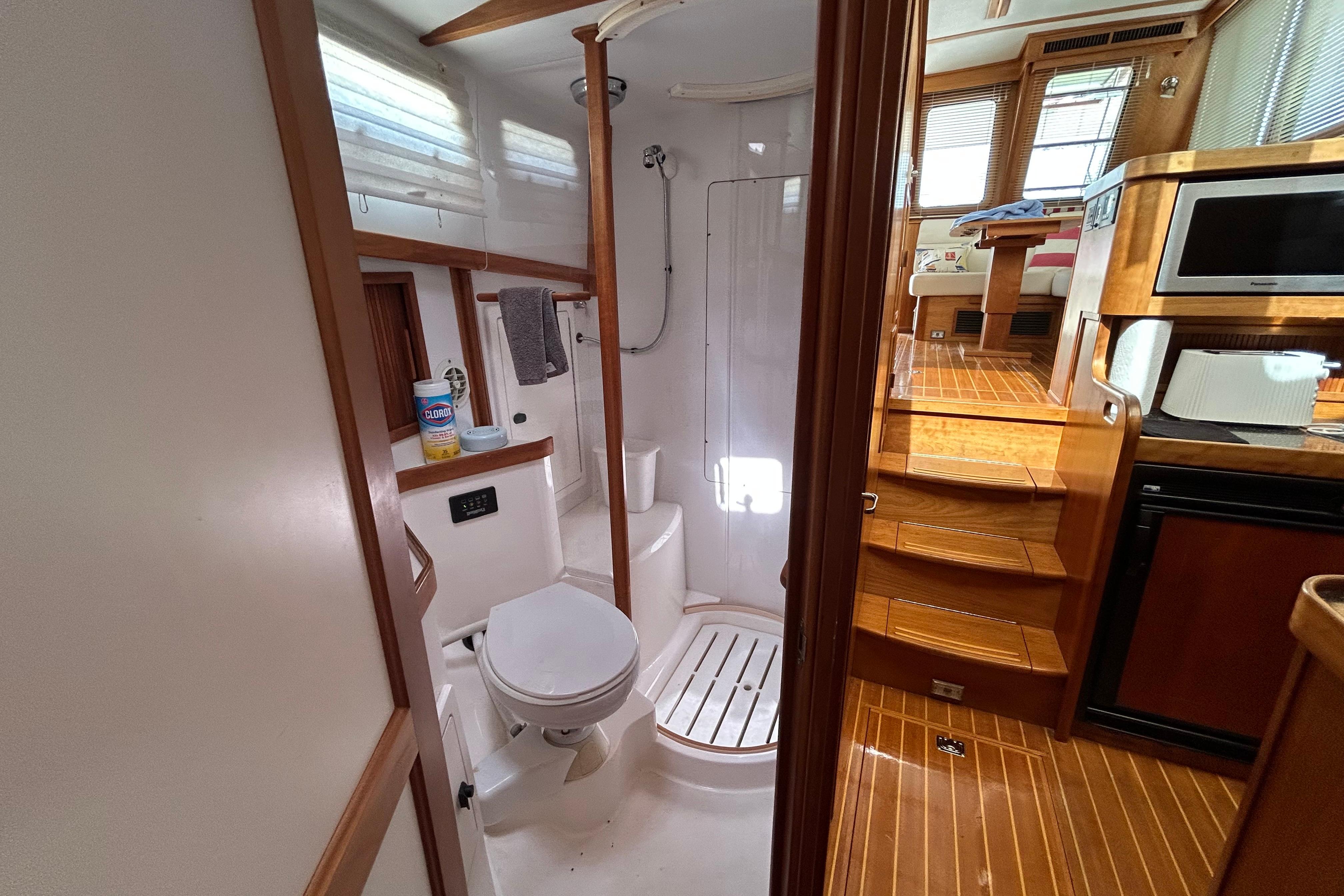 Interior of 2004 Sabre 36 FB yacht showing bathroom and wooden stairs to cabin.