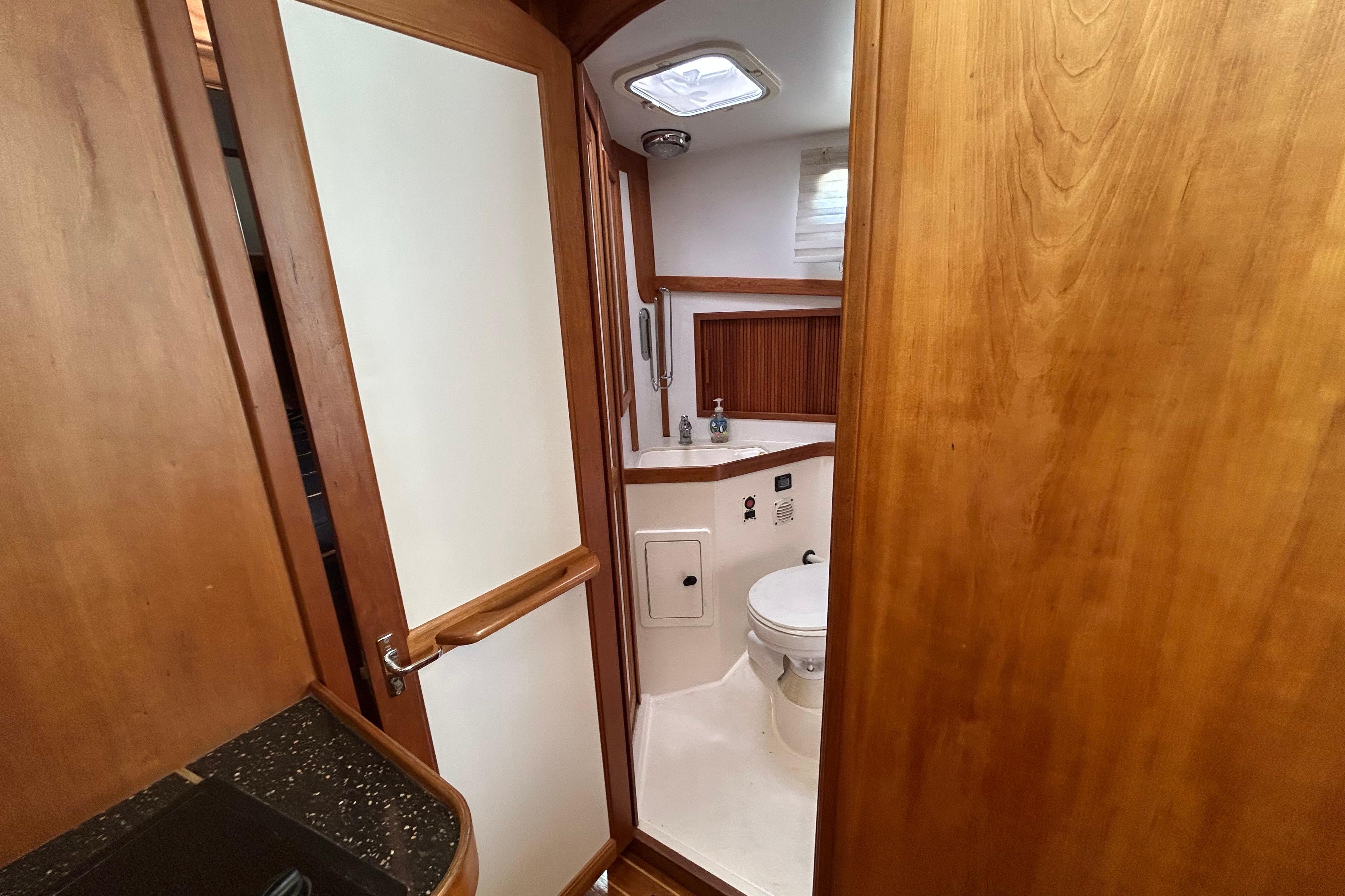 2004 Sabre 36 FB yacht bathroom with wooden cabinetry and modern fixtures.