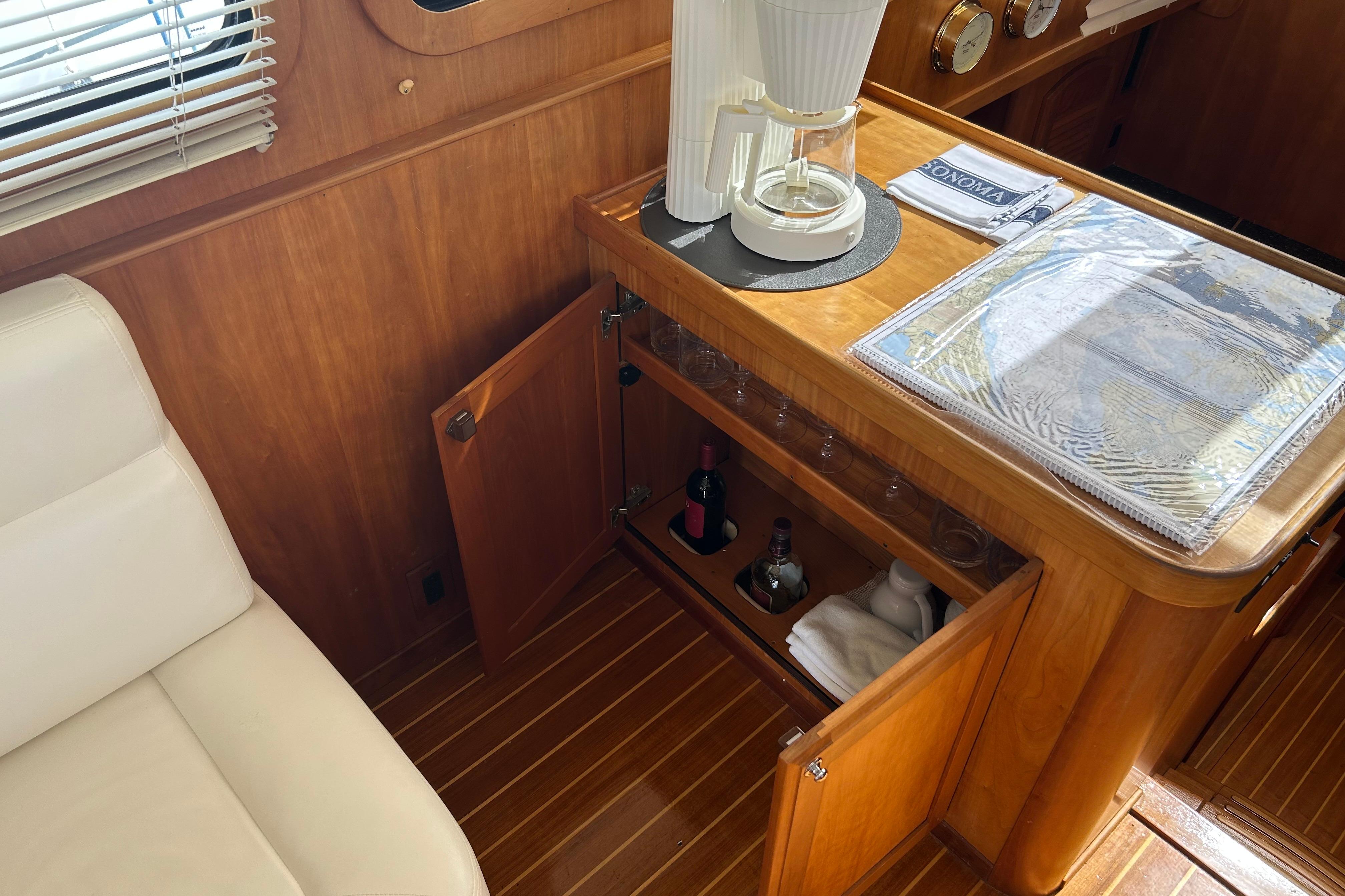 Interior of 2004 Sabre 36 FB yacht with wooden cabinetry and coffee maker.