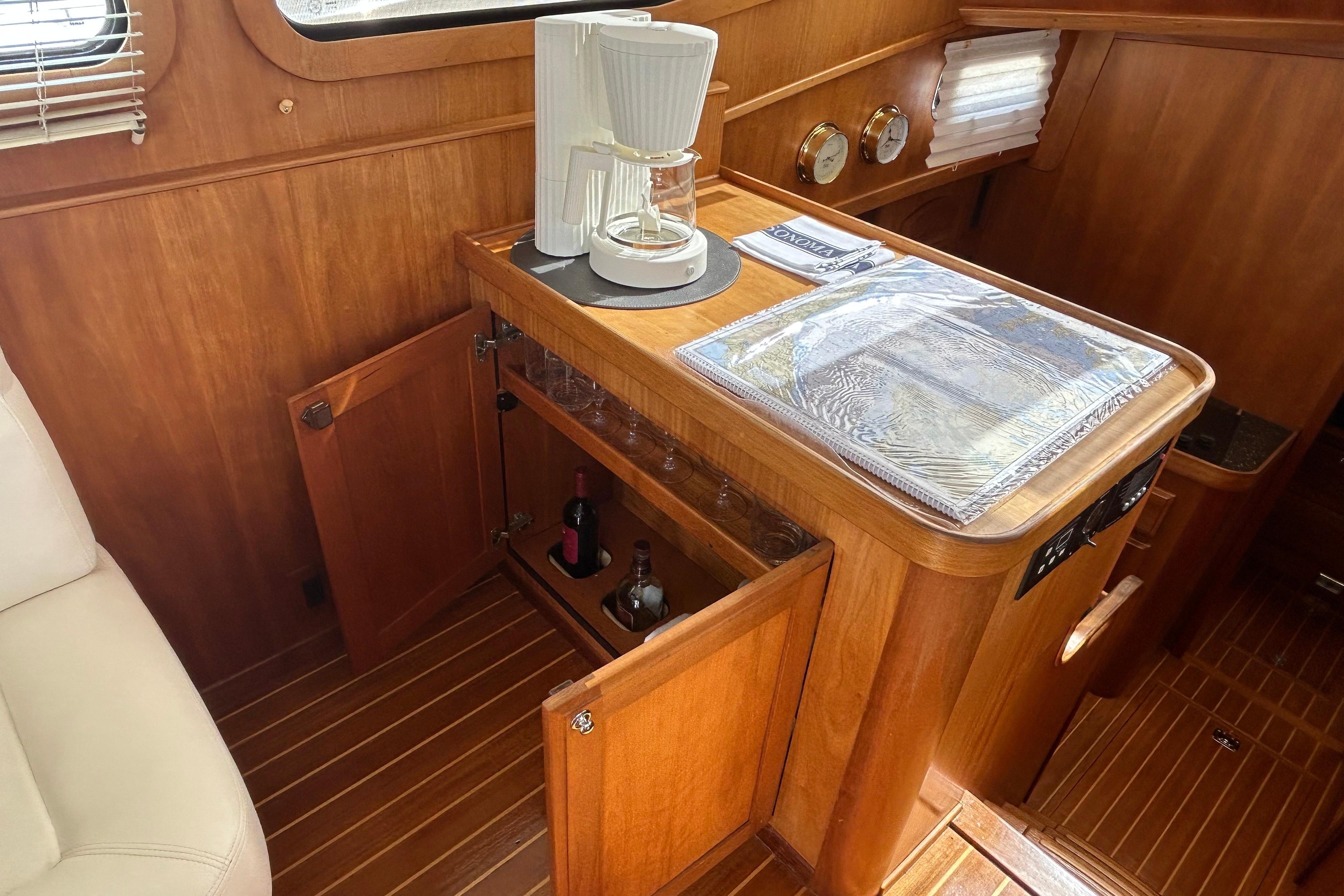 Interior of 2004 Sabre 36 FB yacht with wooden cabinetry and coffee maker.