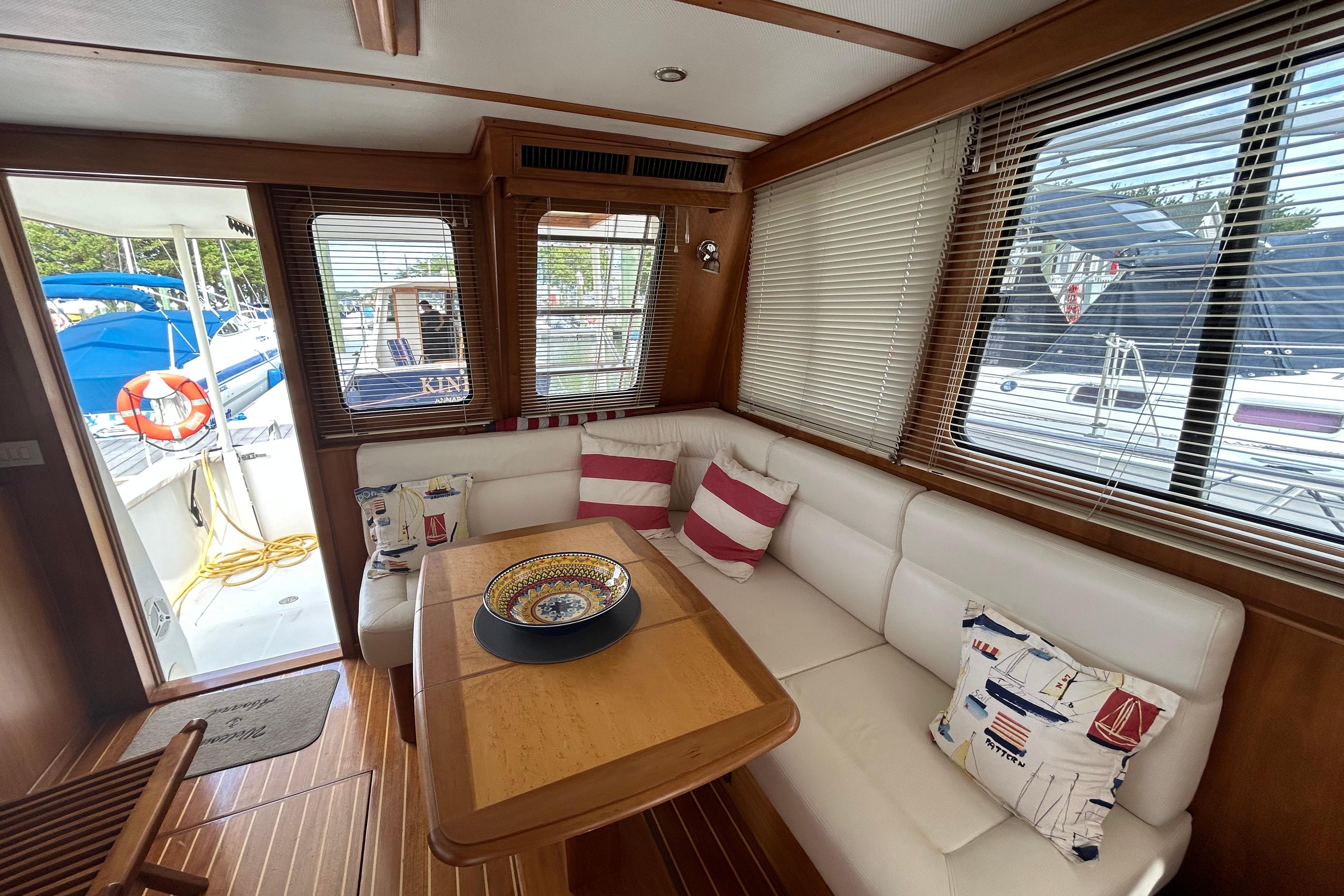 Luxurious interior of 2004 Sabre 36 FB yacht with cozy seating and nautical decor.