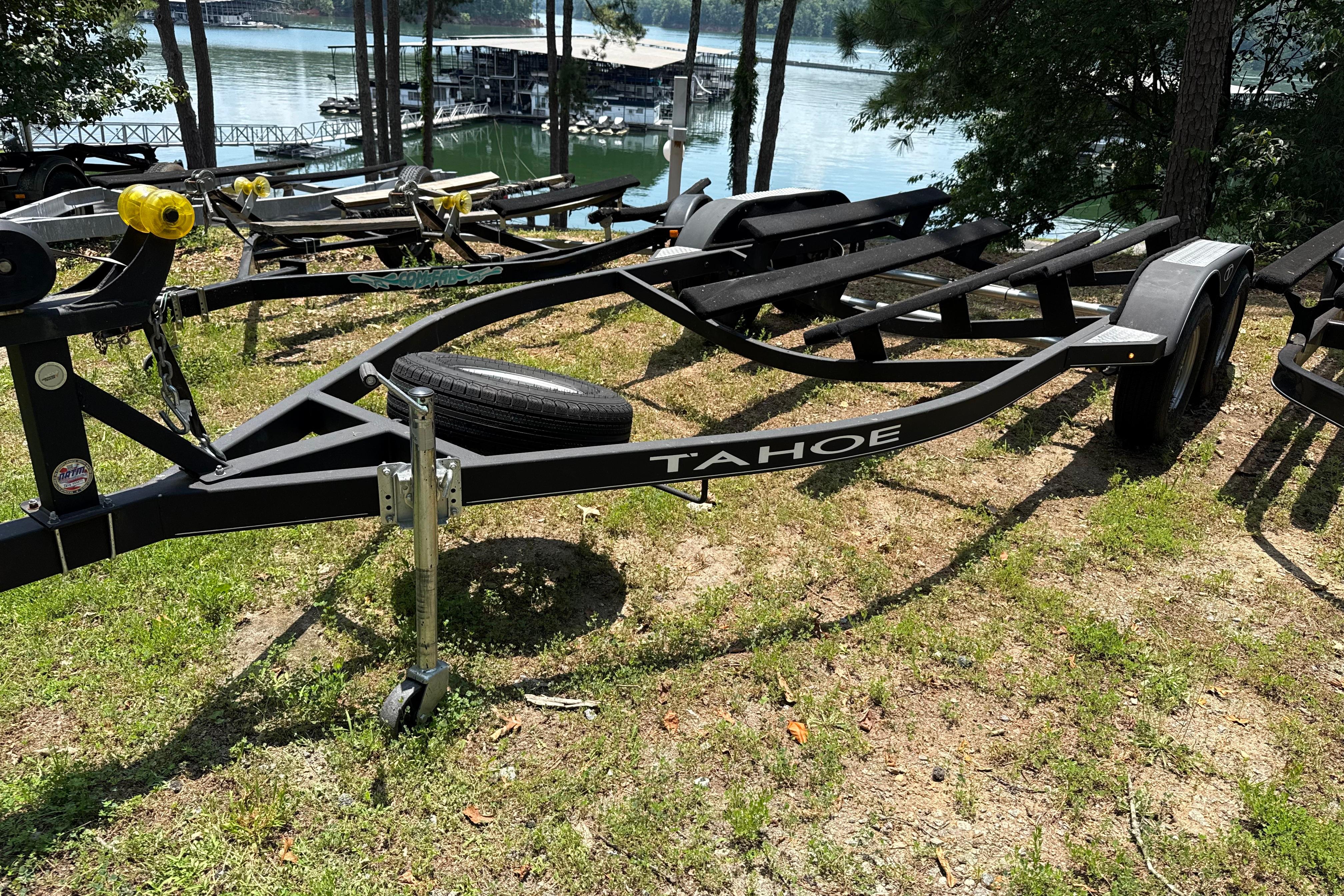 Boat trailer by Tahoe, model 1950, 2021, near a serene lakeside setting.