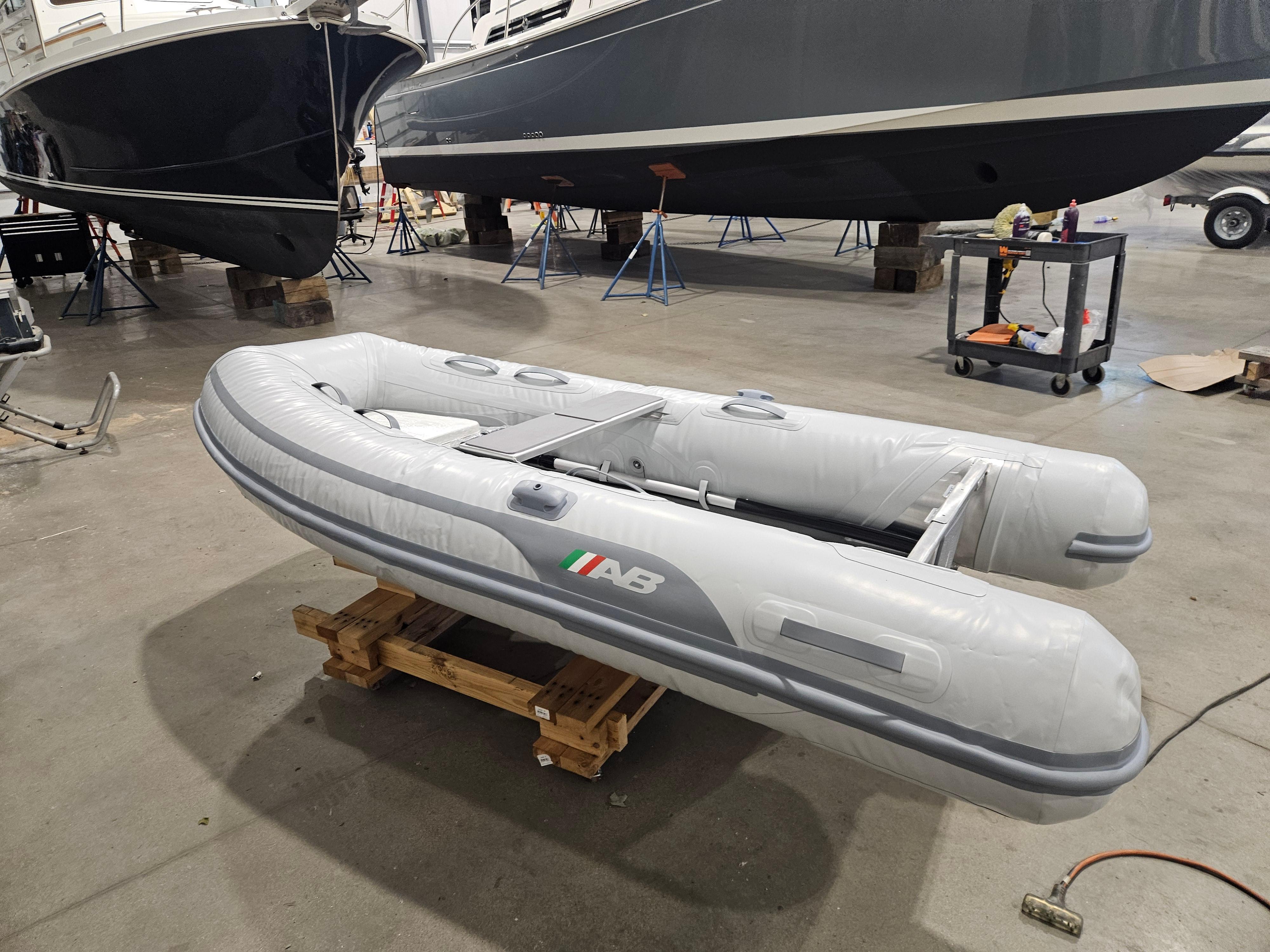 2024 AB Inflatables 9AL boat displayed in a showroom on a wooden pallet.