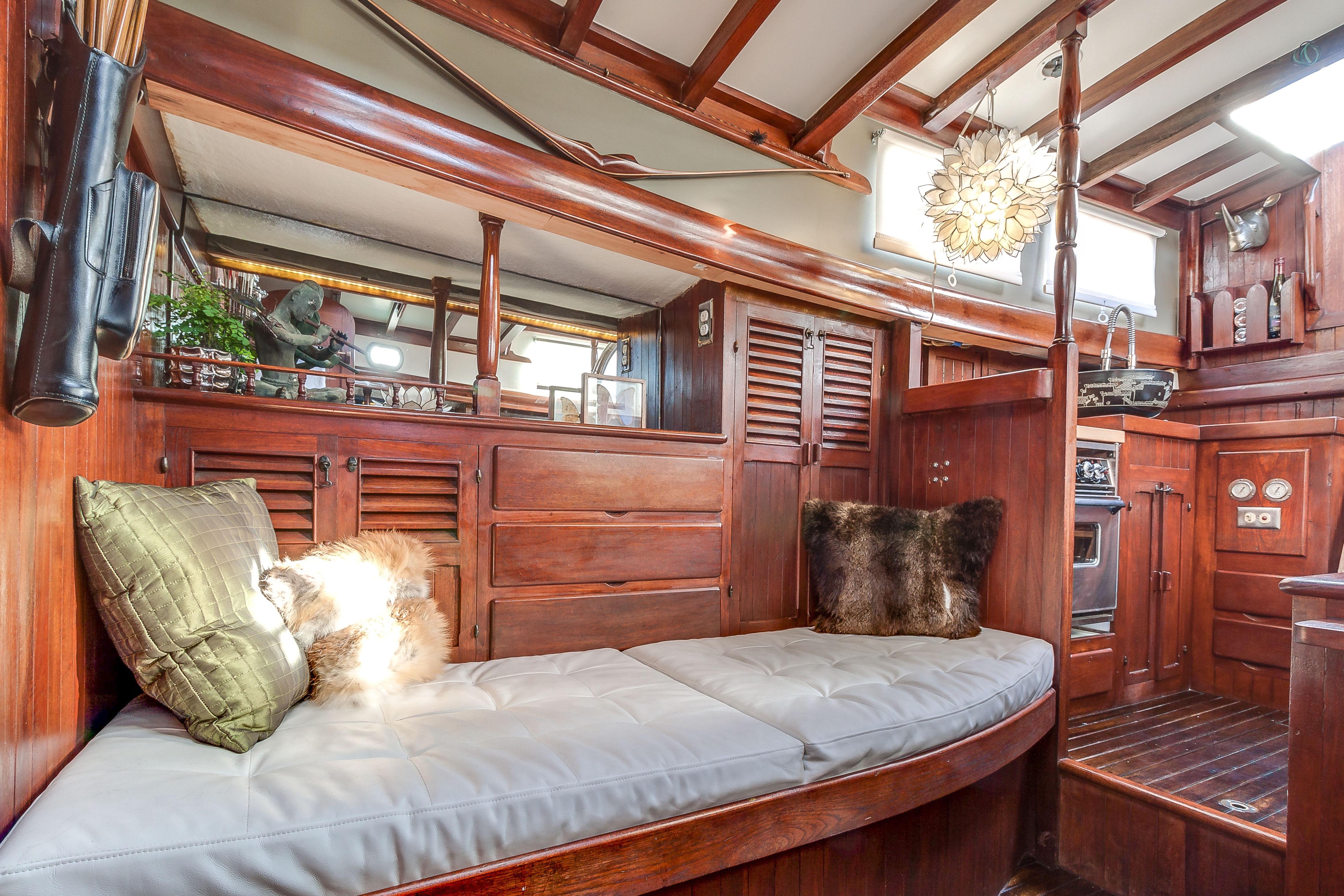 Interior of a 1971 Formosa 41 sailboat with wooden furnishings and cozy seating.