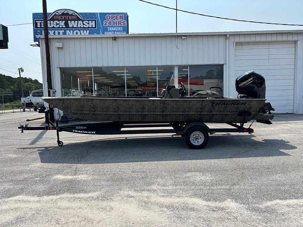 2025 Tracker Grizzly 2072 CC boat on trailer, parked outside a truck wash facility.