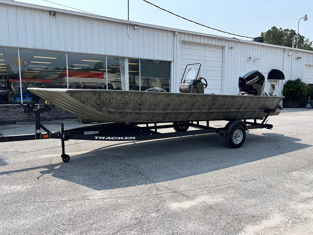 2025 Tracker Grizzly 2072 CC boat on trailer outside dealership.