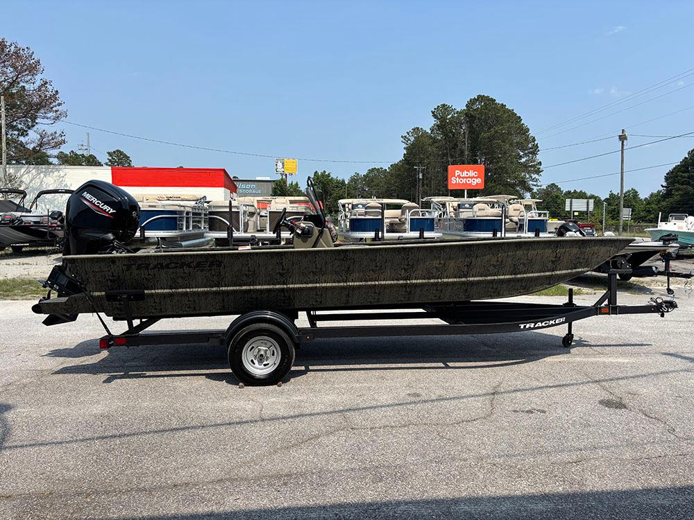 2025 Tracker Grizzly 2072 CC boat on trailer in outdoor storage area.