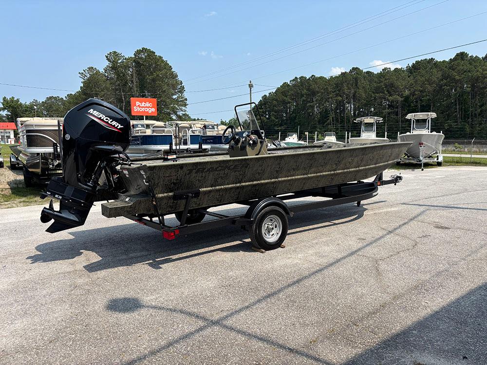 2025 Tracker Grizzly 2072 CC boat with Mercury engine on trailer, parked outdoors.