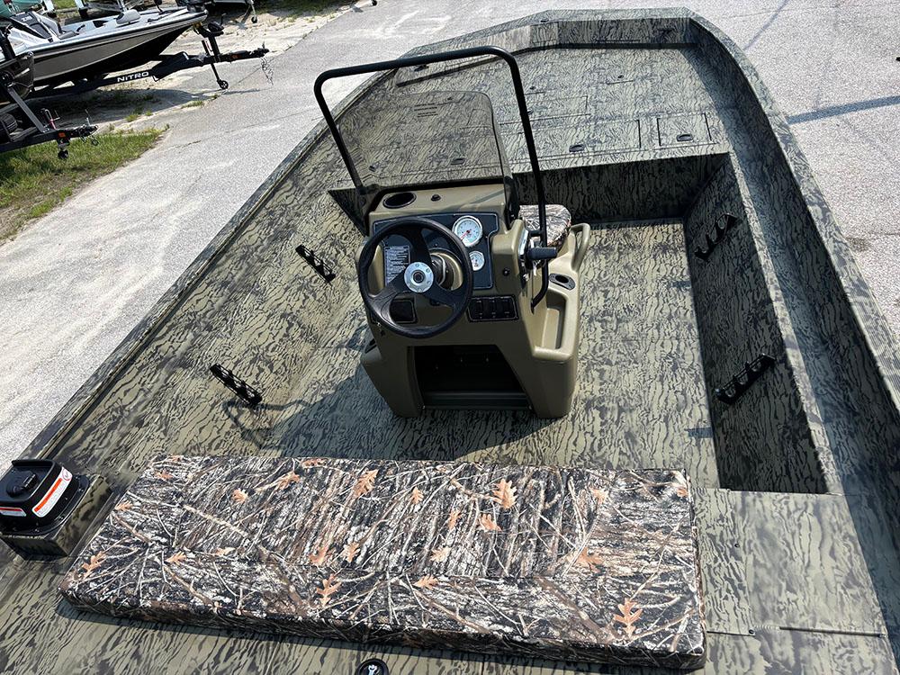 2025 Tracker Grizzly 2072 CC boat interior with camo seating and steering console.