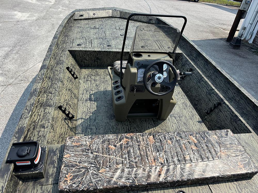 2025 Tracker Grizzly 2072 CC boat with camouflage design and central steering console.