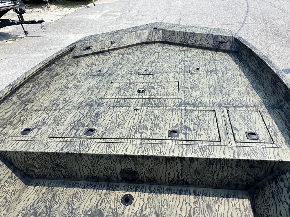 2025 Tracker Grizzly 2072 CC boat deck with camouflage pattern, featuring storage compartments.