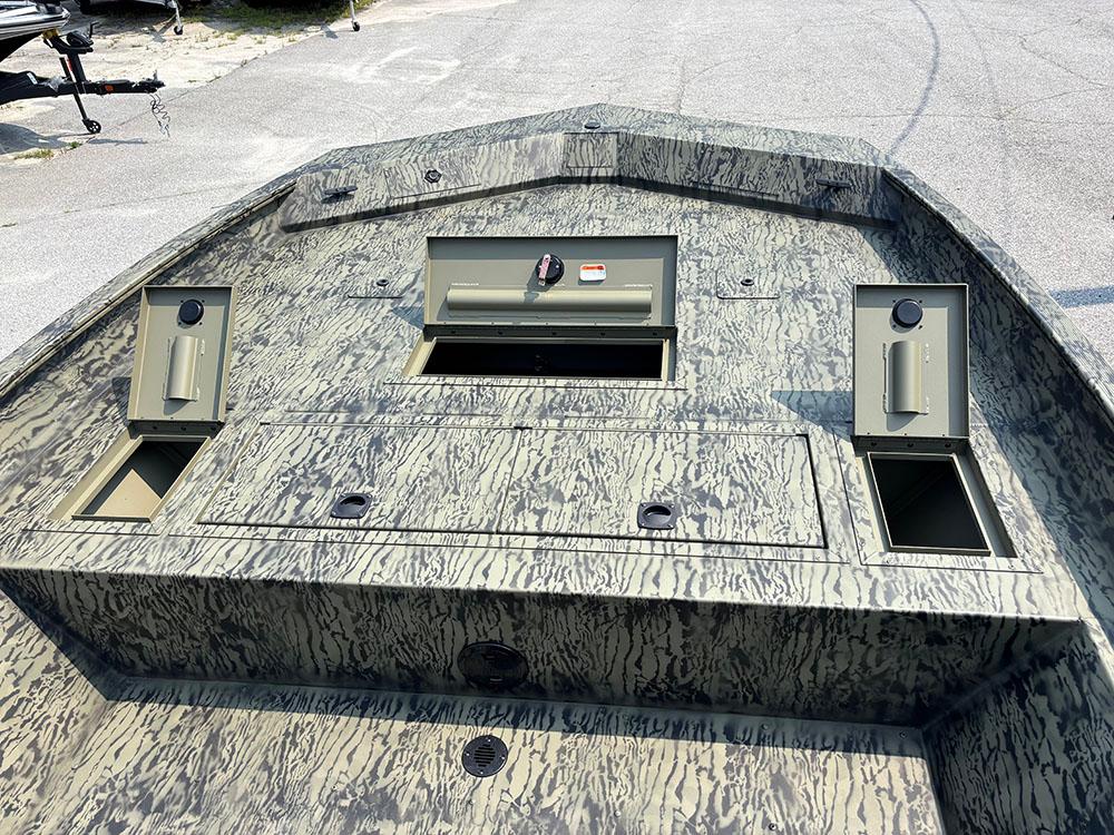 2025 Tracker Grizzly 2072 CC boat with camo design and storage compartments.