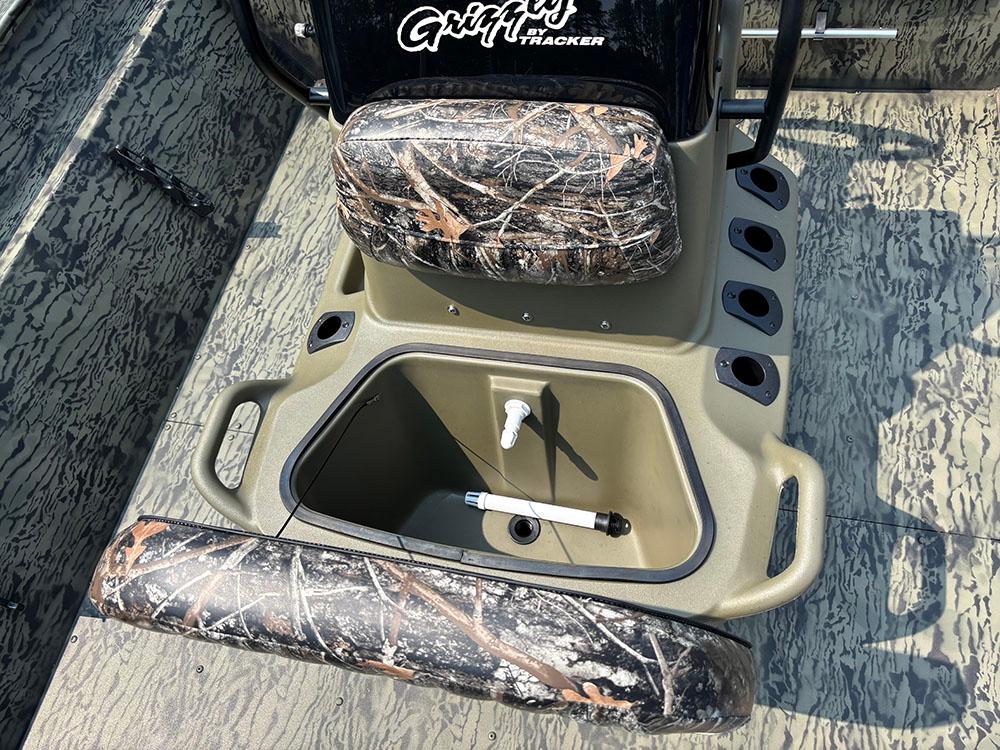 2025 Tracker Grizzly 2072 CC boat interior with camo seats and storage compartment.