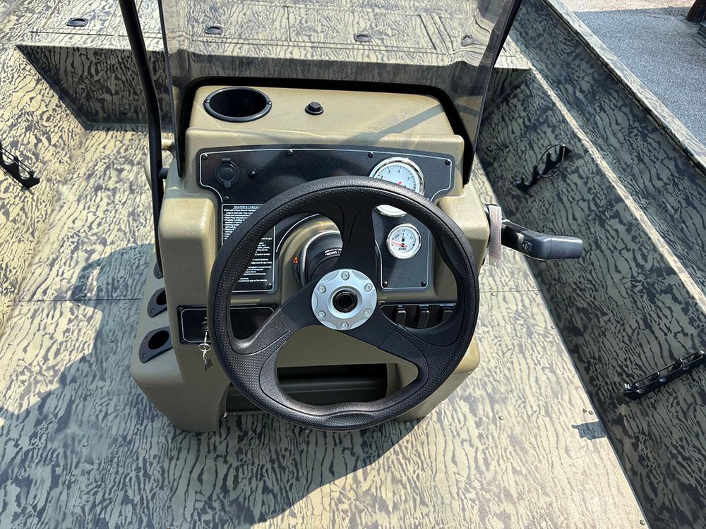 2025 Tracker Grizzly 2072 CC boat console with steering wheel and gauges.