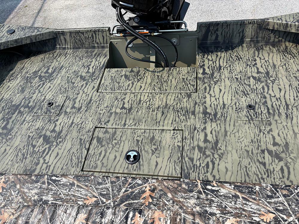 2025 Tracker Grizzly 2072 CC boat deck with camouflage pattern and storage compartments.