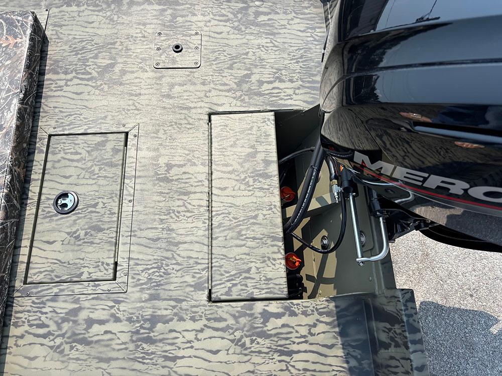 2025 Tracker Grizzly 2072 CC boat deck with camo pattern and Mercury outboard motor.