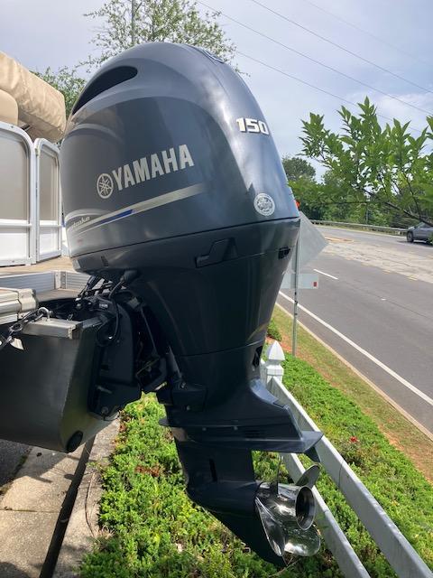 2020 G3 SunCatcher V322FC with Yamaha 150 outboard motor, parked near a road.
