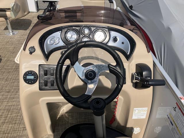 Steering console of 2020 G3 SunCatcher V322FC boat with gauges and controls.