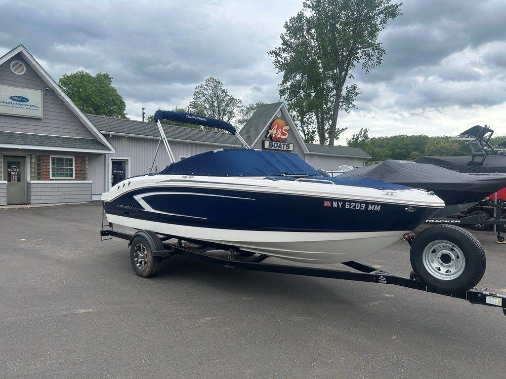 2017 Chaparral 21 H2O Sport boat on trailer, parked outside dealership.
