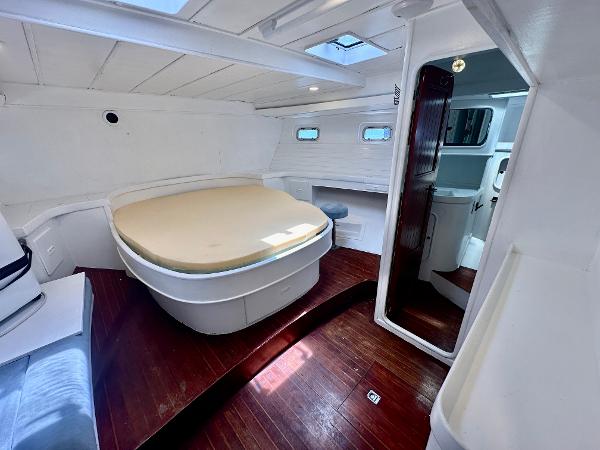 Interior of 1983 Tayana 55 yacht with spacious cabin and wooden flooring.