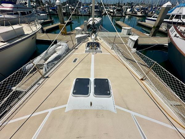 Deck view of 1983 Tayana 55 sailboat docked in a marina.