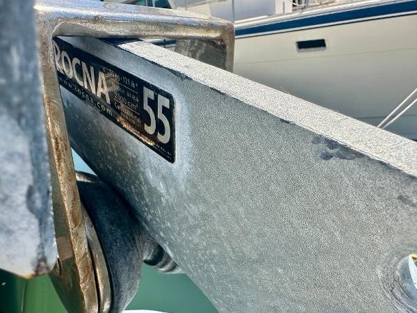 Anchor detail on a 1983 Tayana 55 sailboat, featuring Rocna 55 branding.
